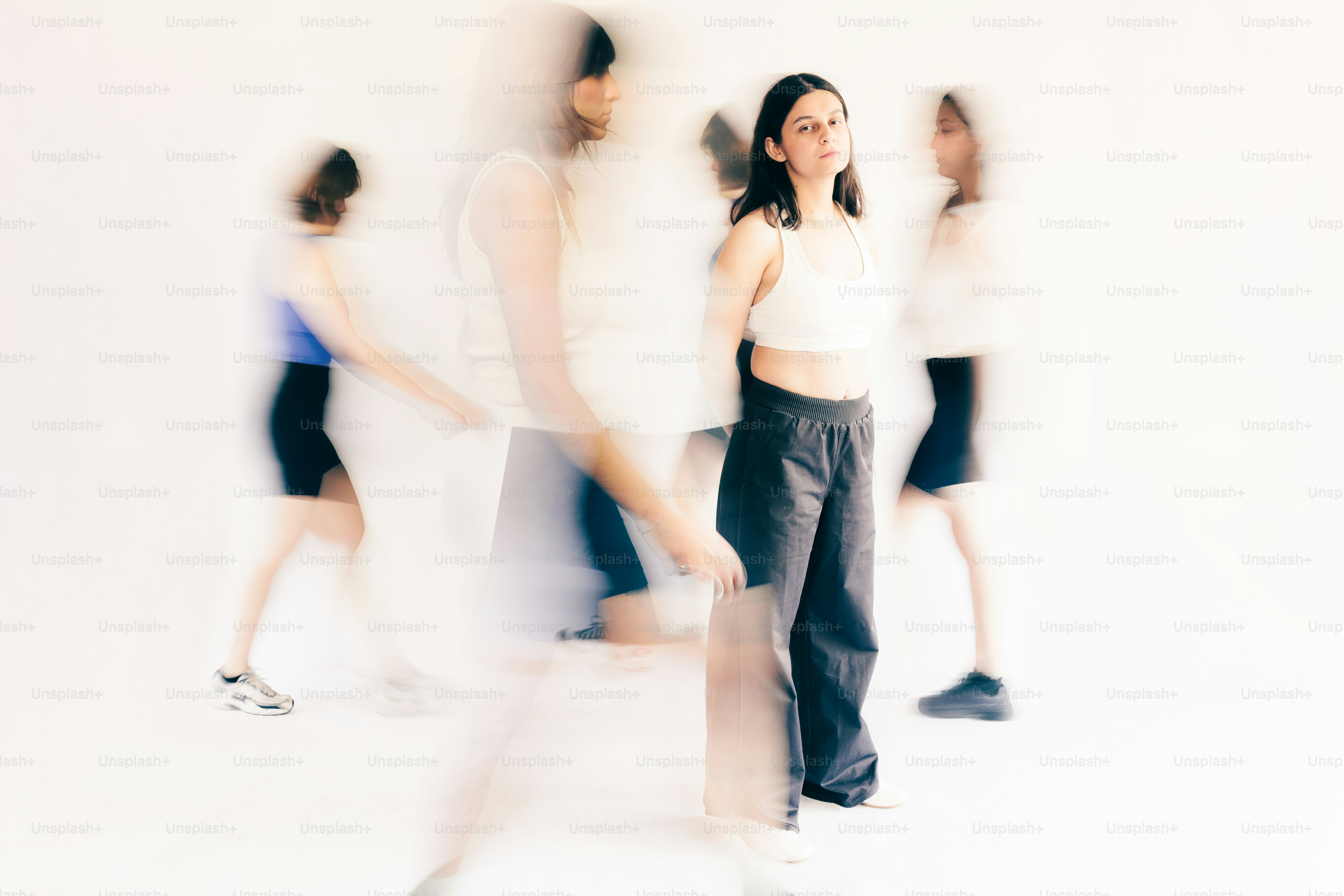 A woman stands still while others move around her