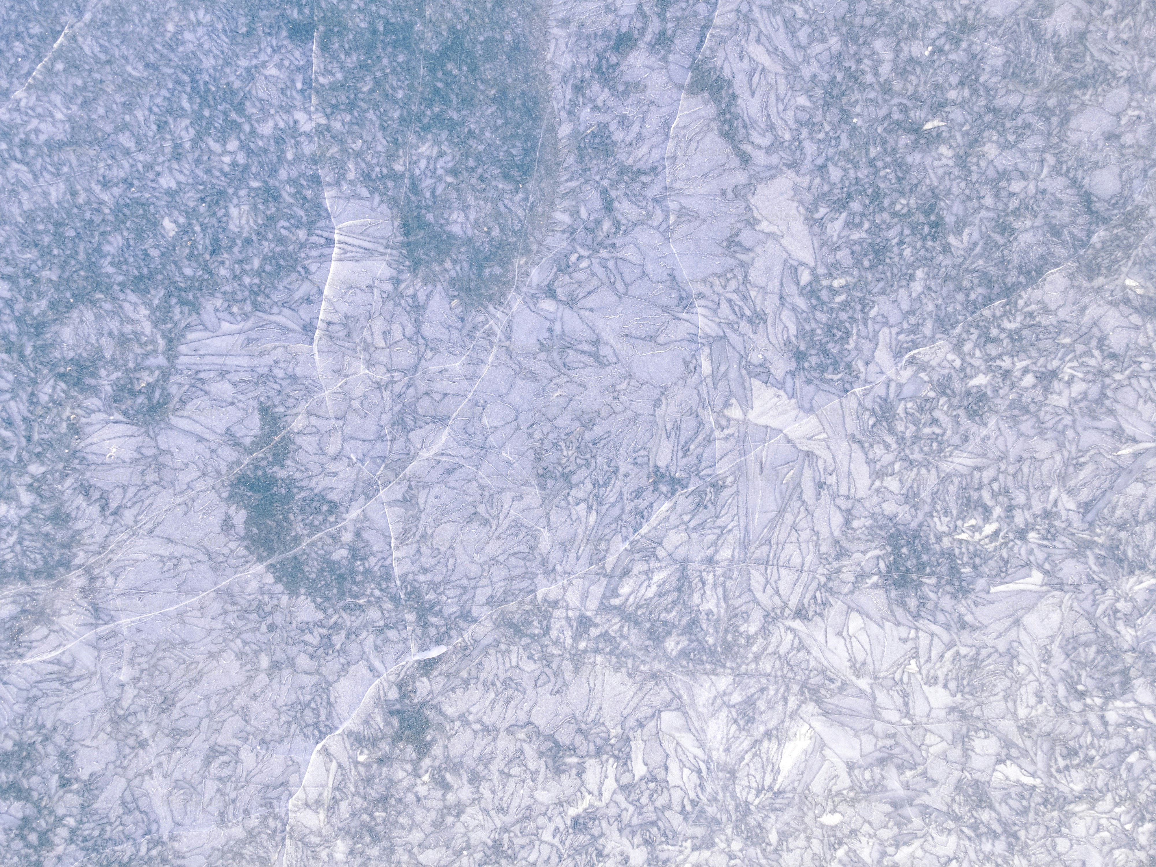 Abstract icy texture with blue and white hues.