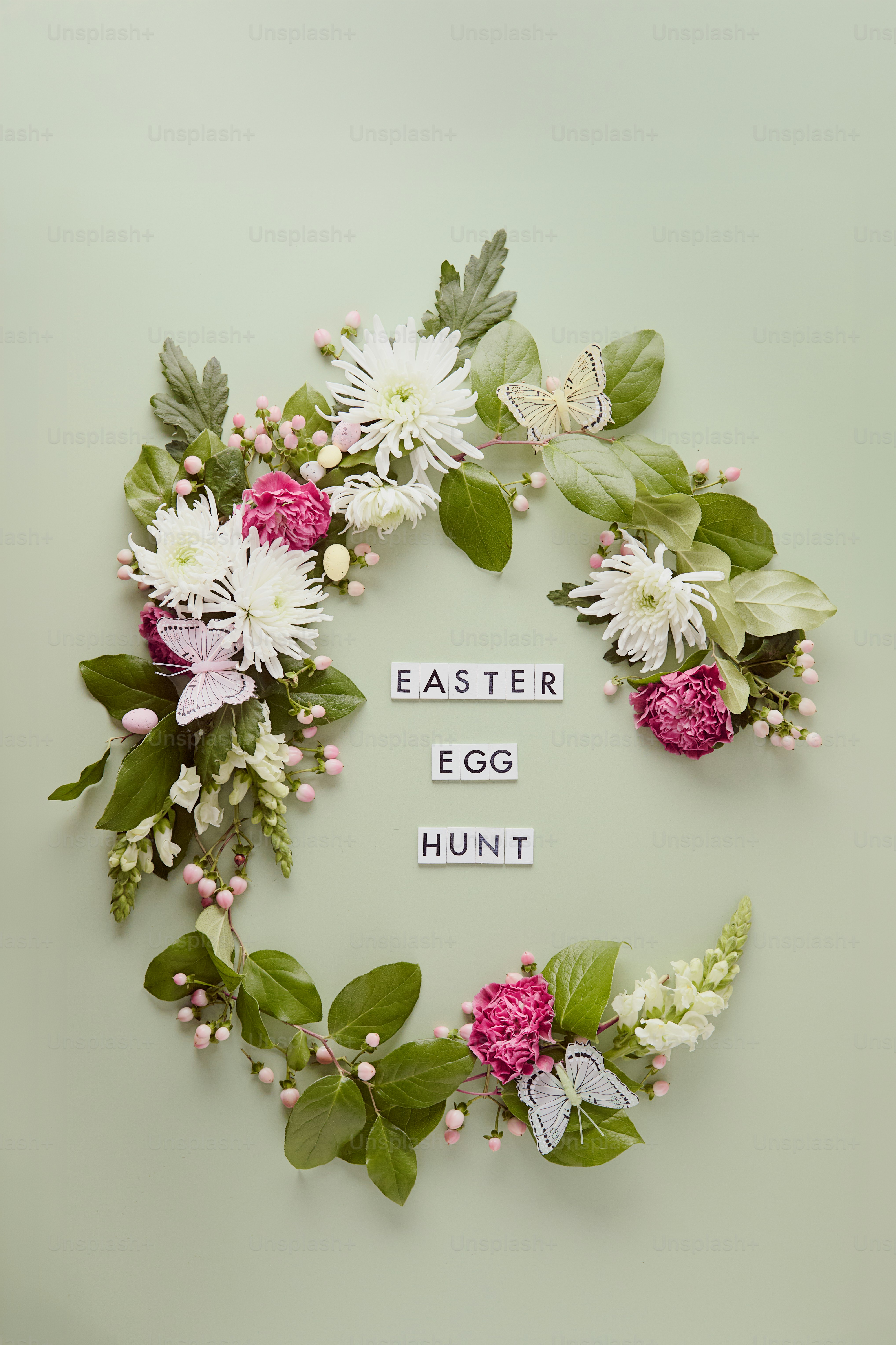 Easter egg hunt with floral wreath and butterflies