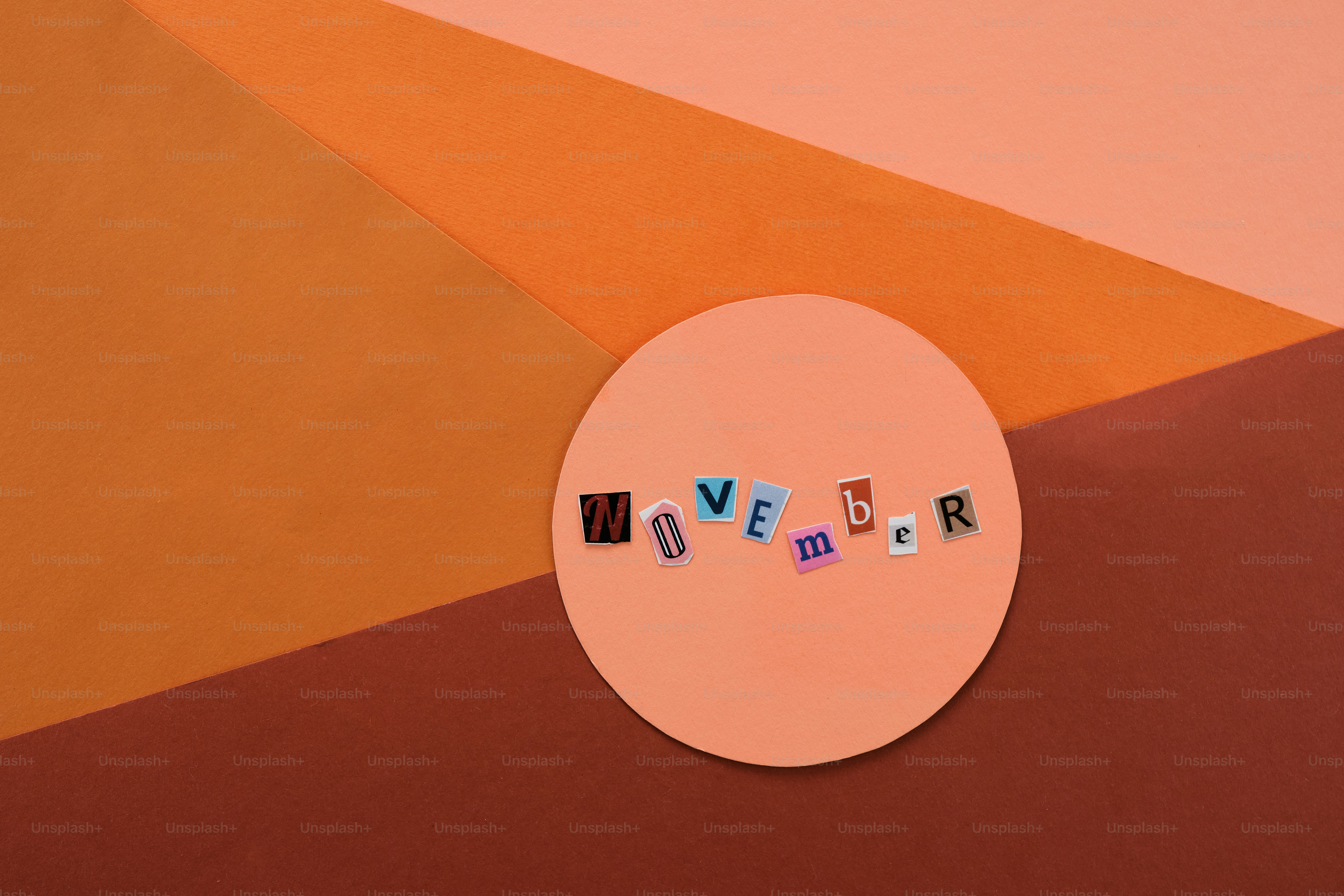 Cutout letters spell november on a peach circle.