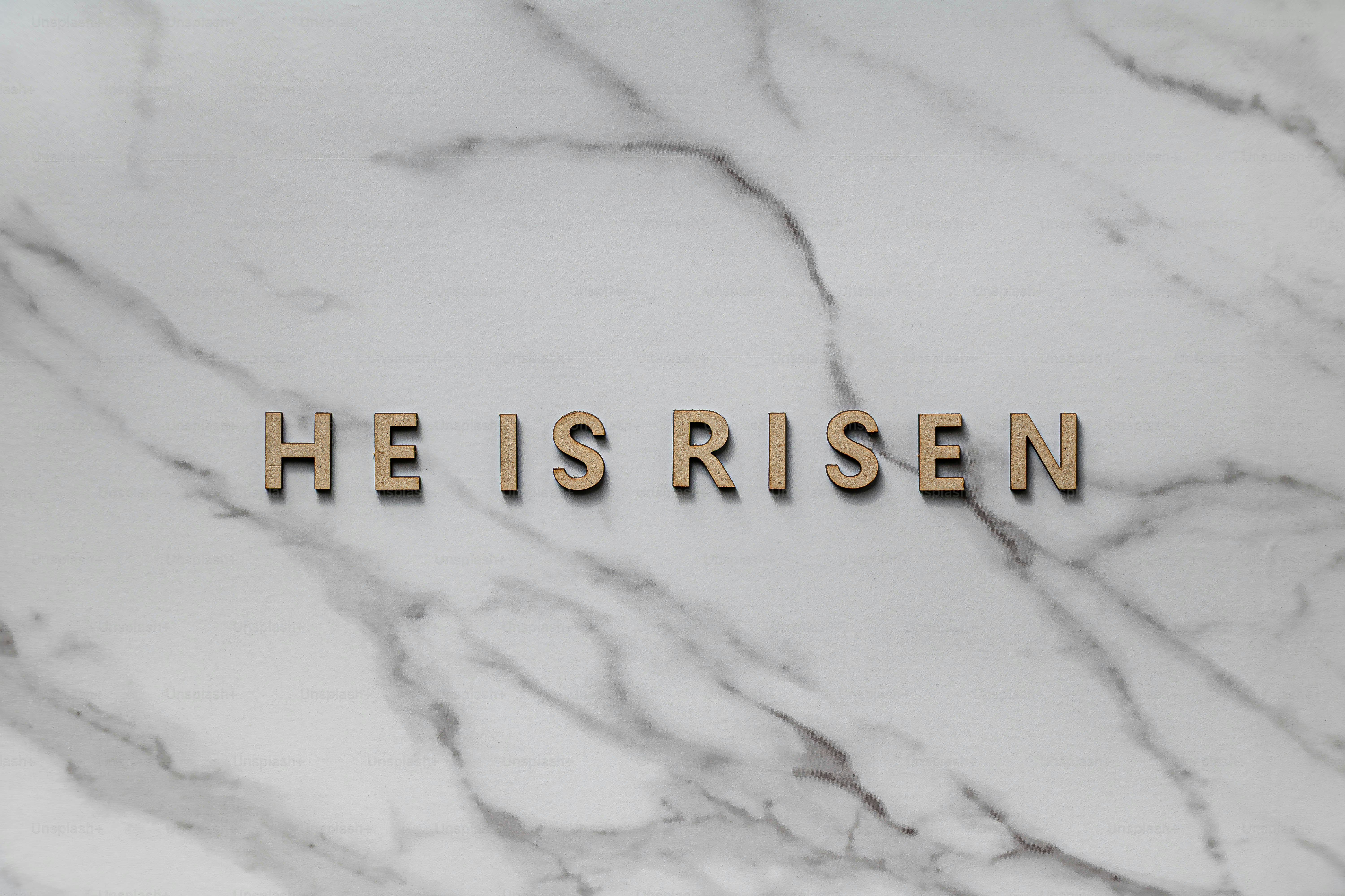 Golden letters spell out he is risen on marble. photo – Minimalist ...