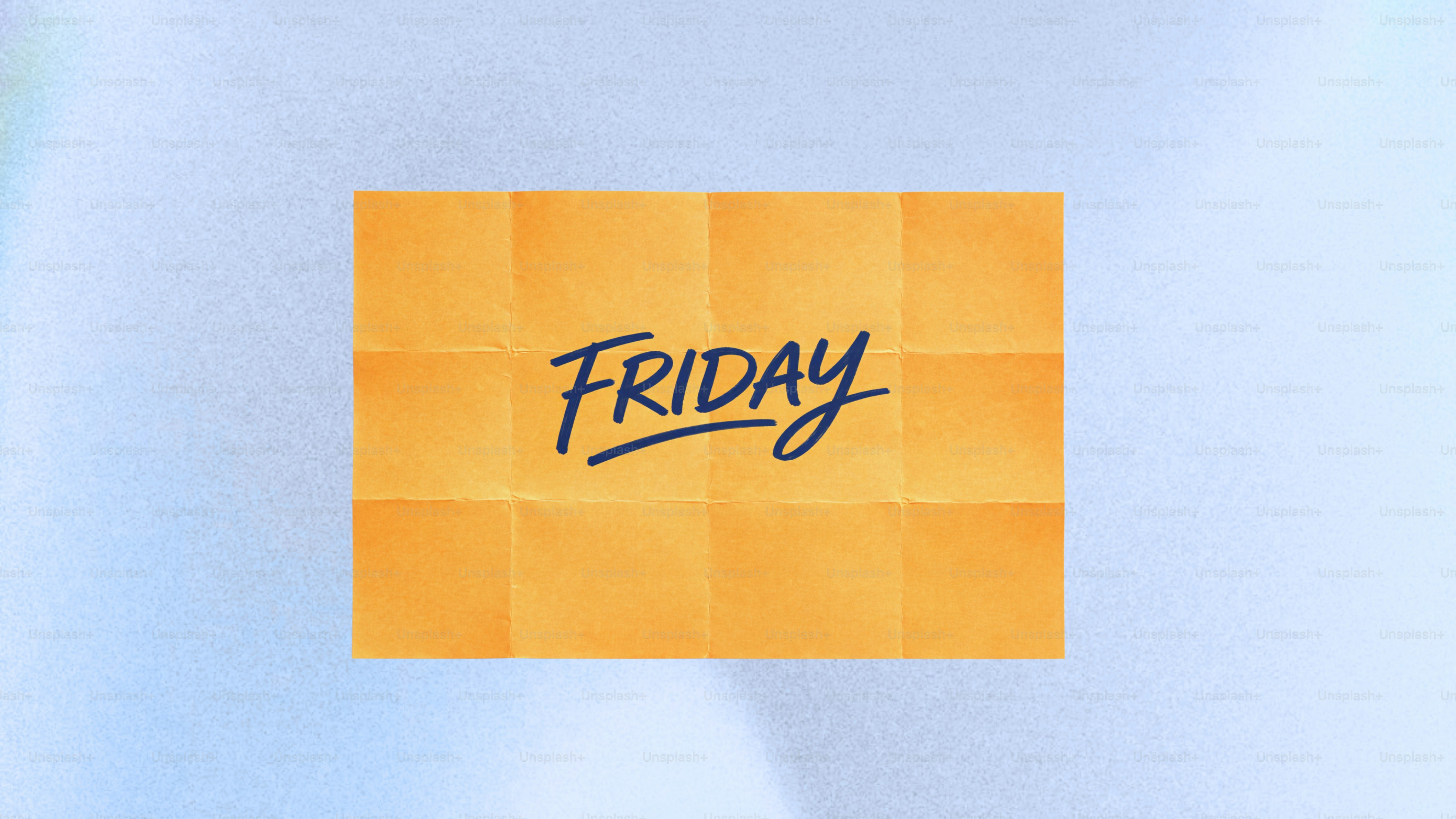 The word friday written on an orange sticky note.