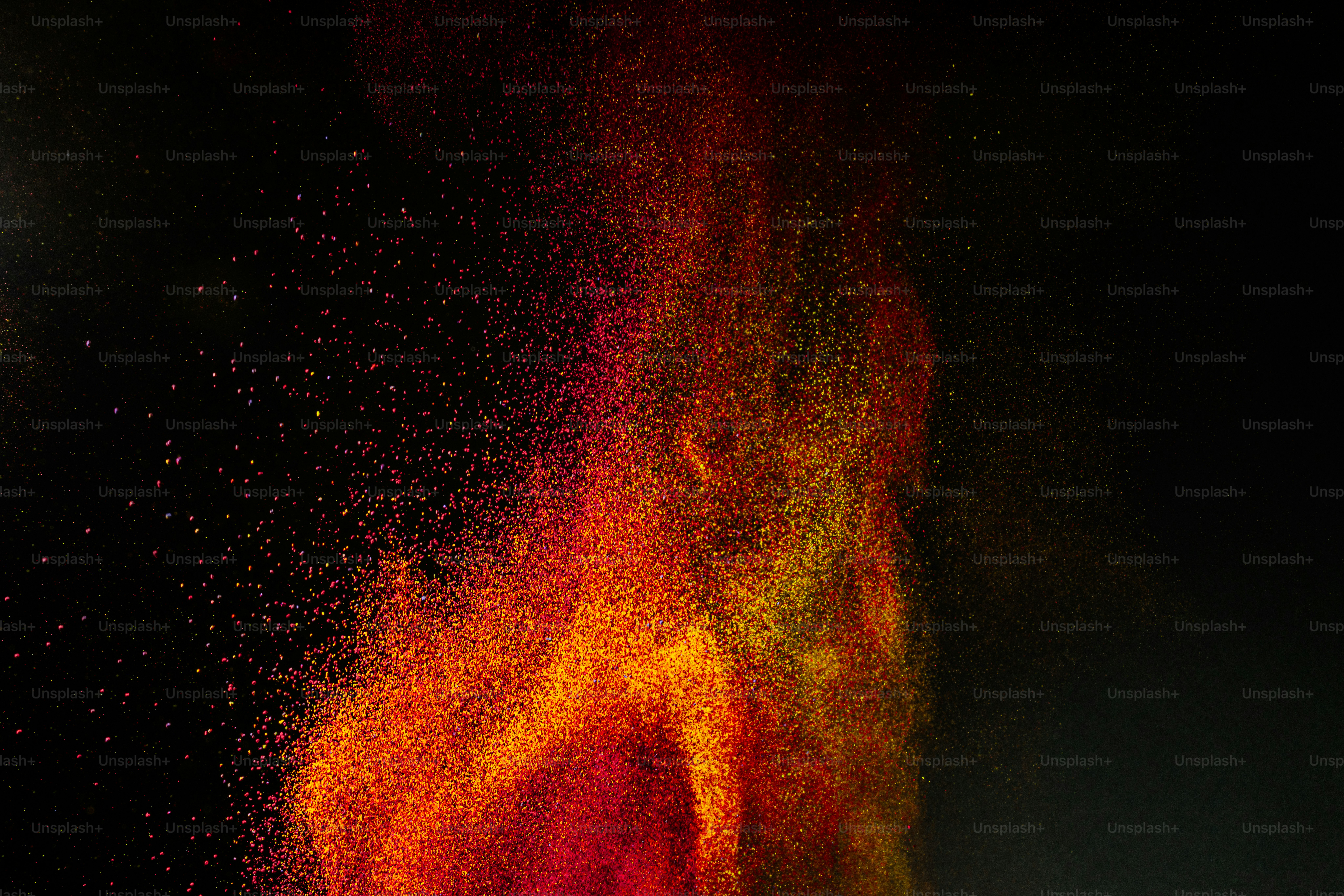 Fiery explosion of colored powder against black background photo ...
