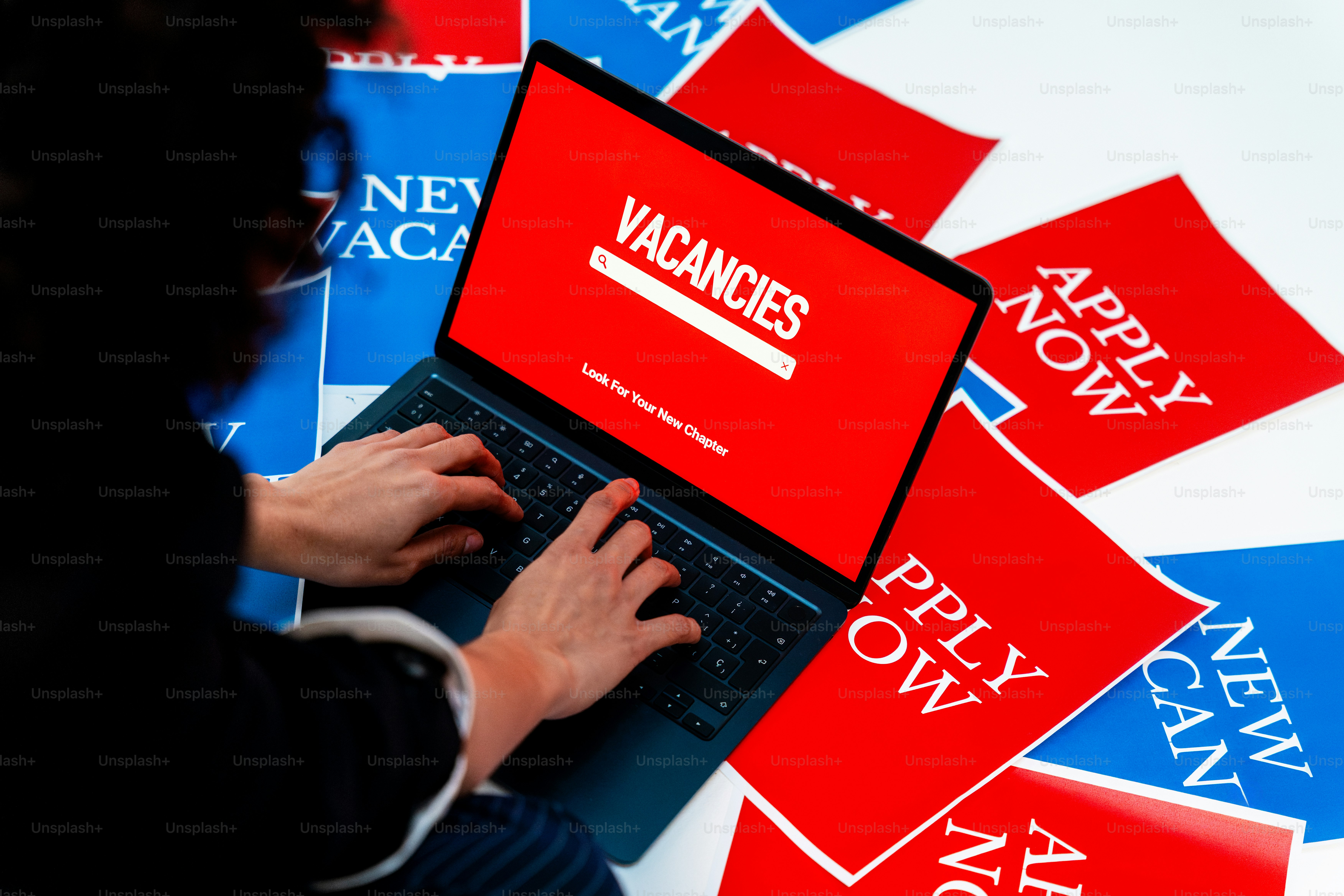 Person applying for vacancies online with laptop.