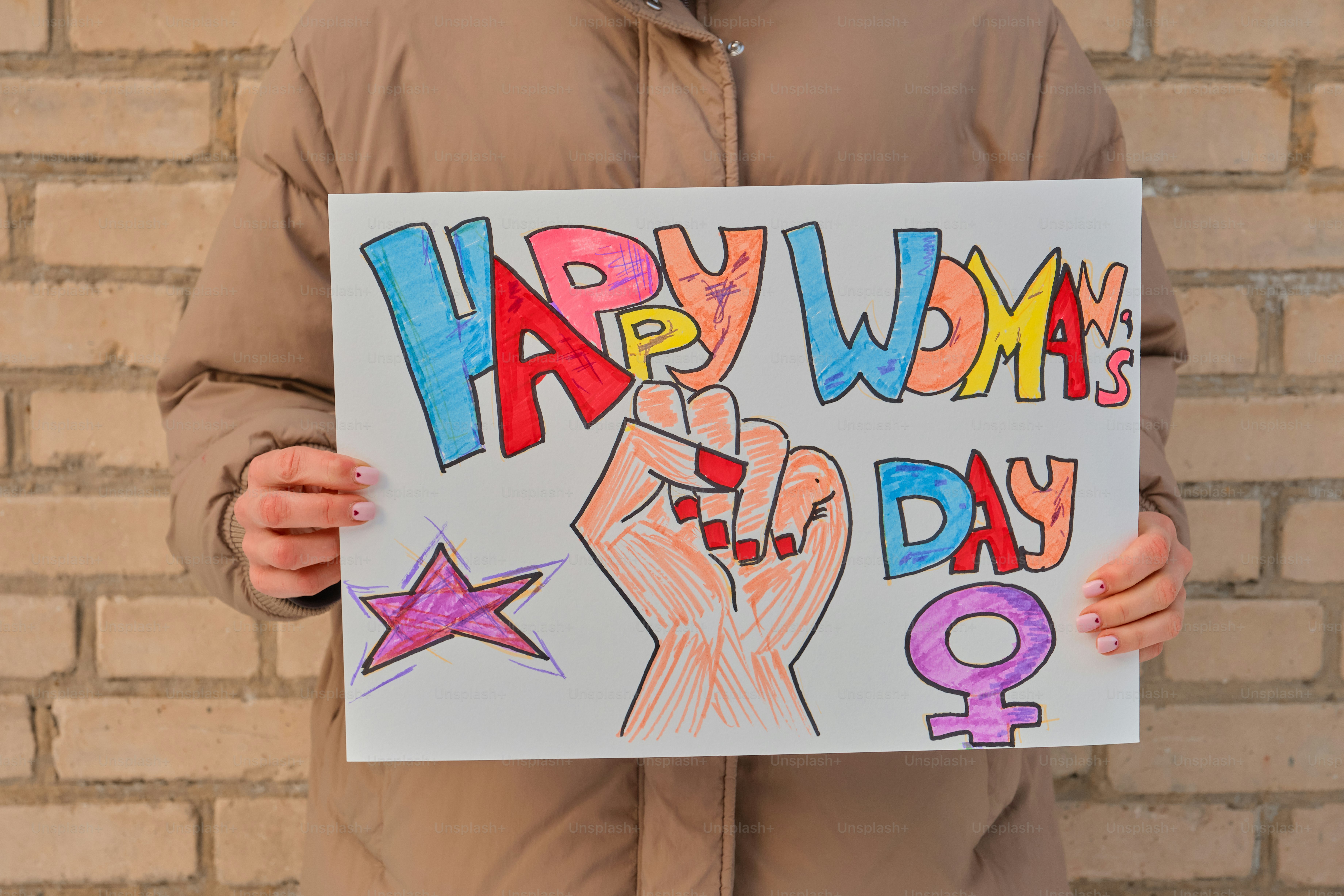 Person holding a happy woman's day sign