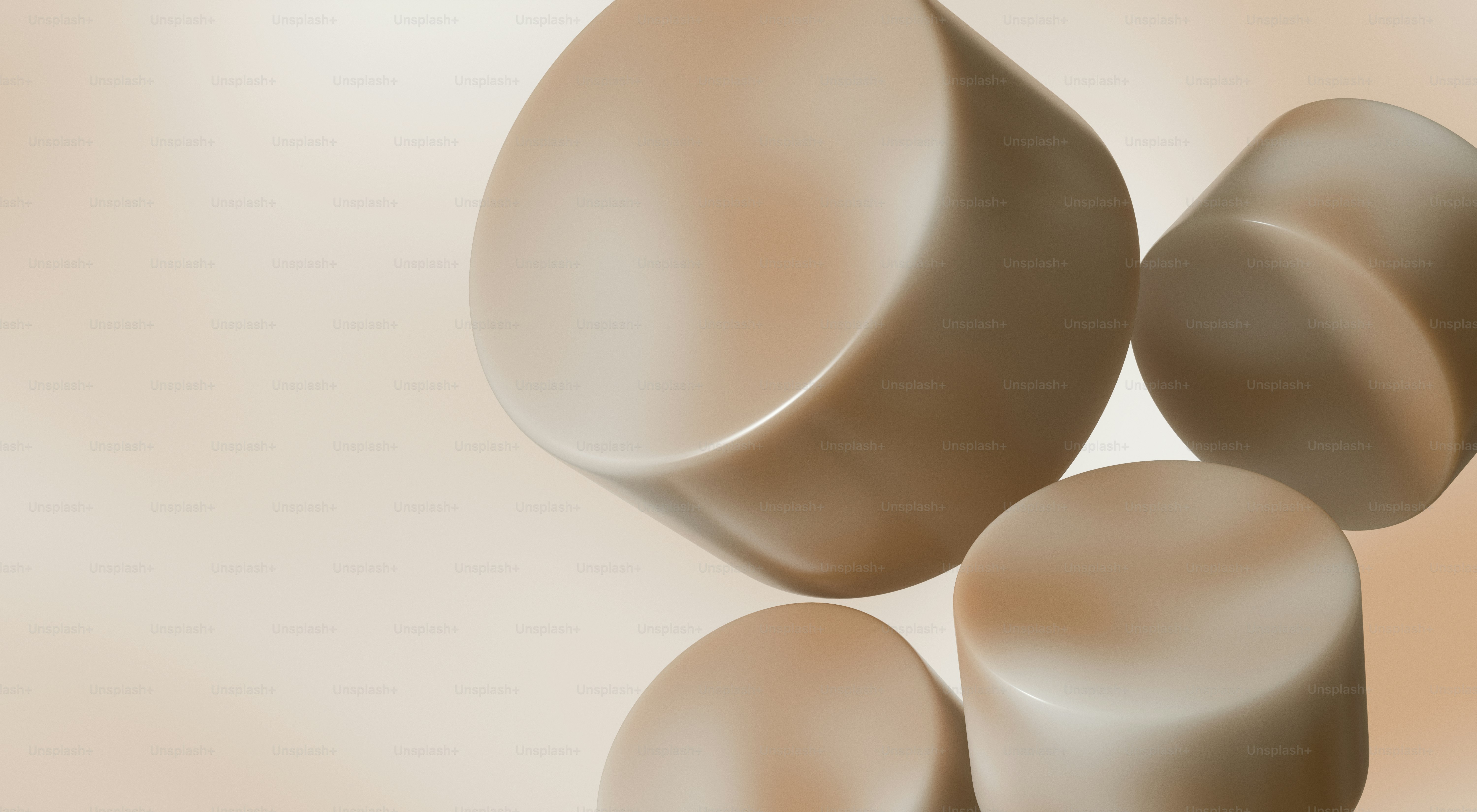 Several beige cylindrical objects floating against a light background
