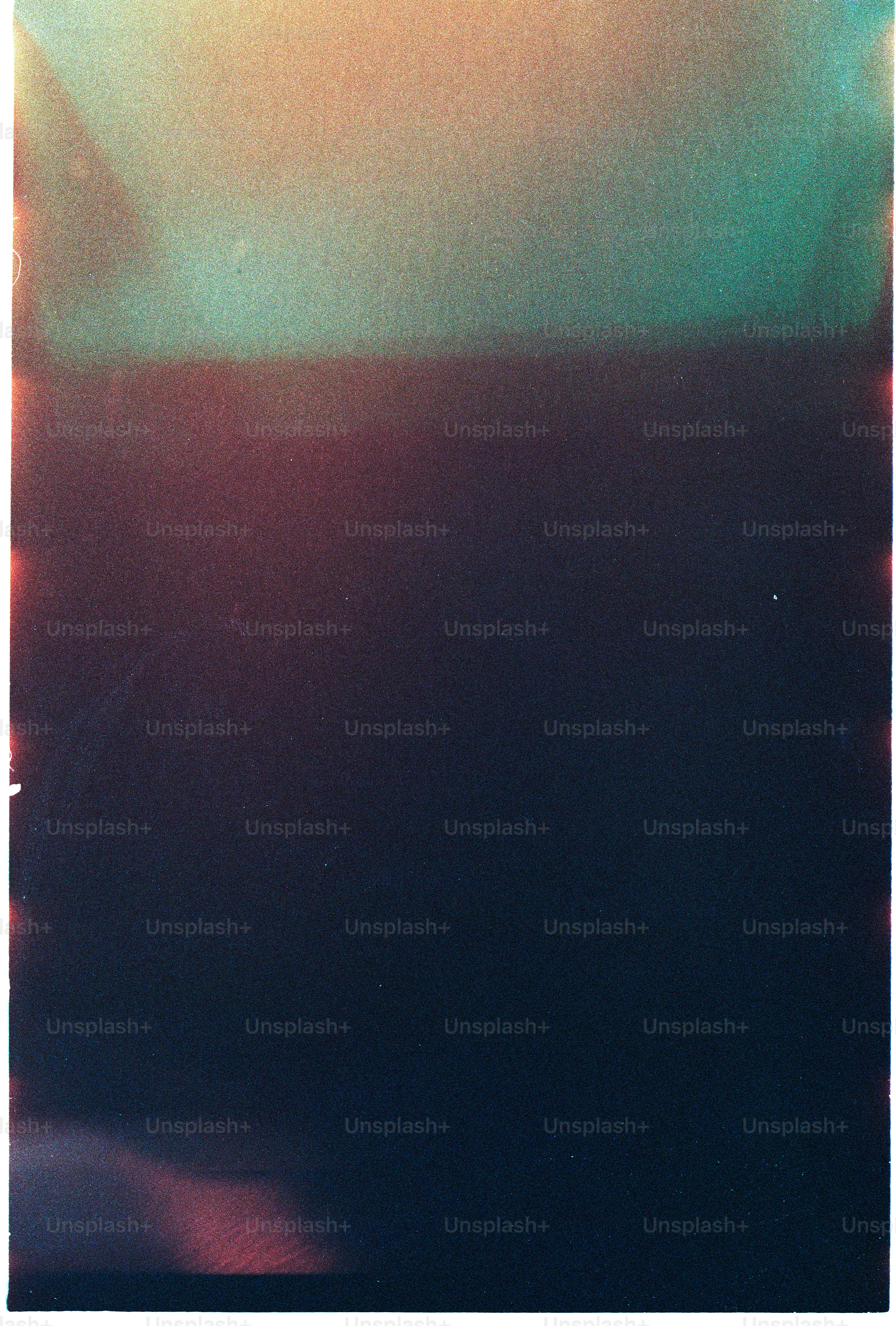 Abstract blend of dark blue, red, and teal colors.