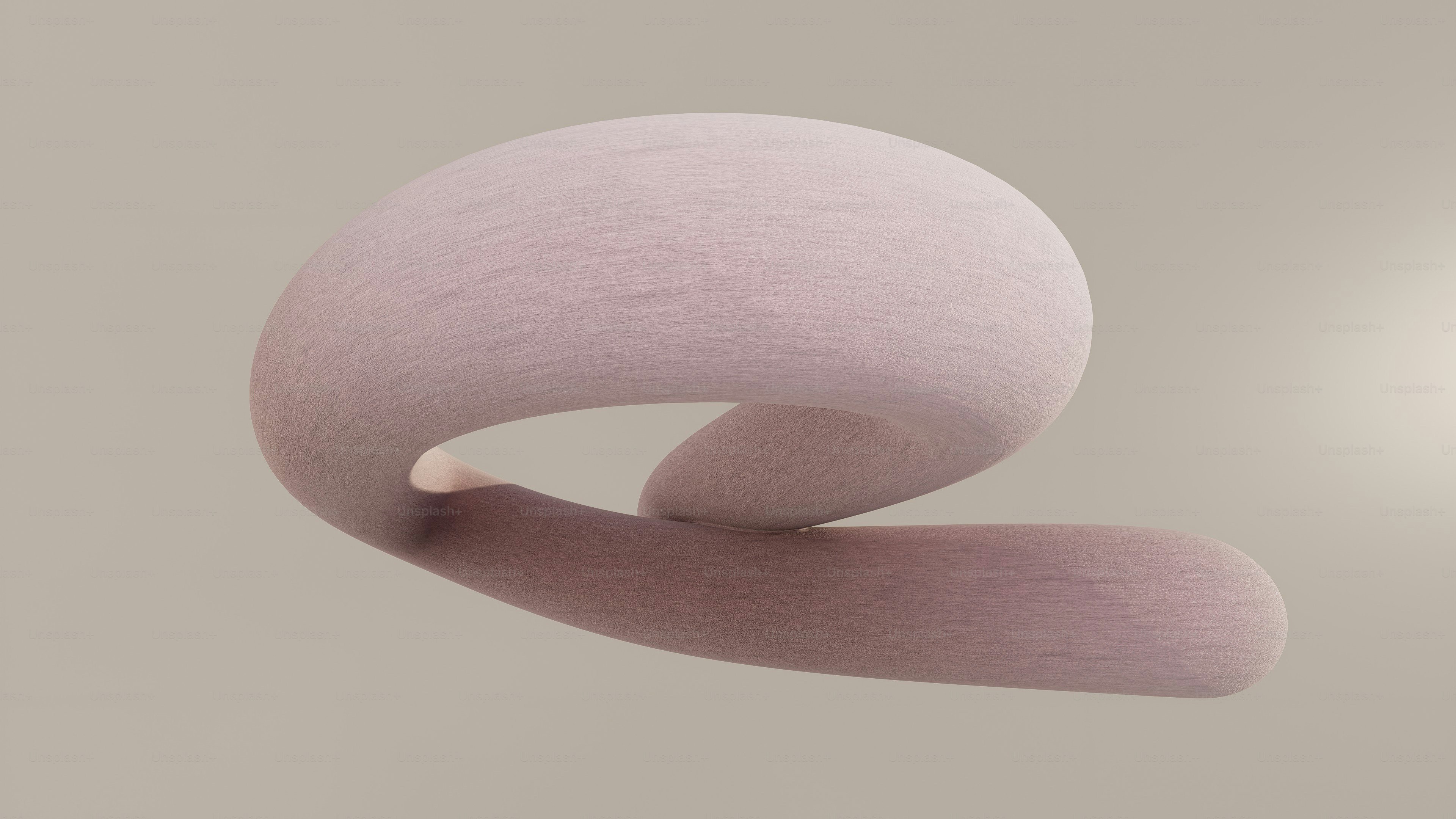 A soft, pink, abstract shape floats against a pale background.