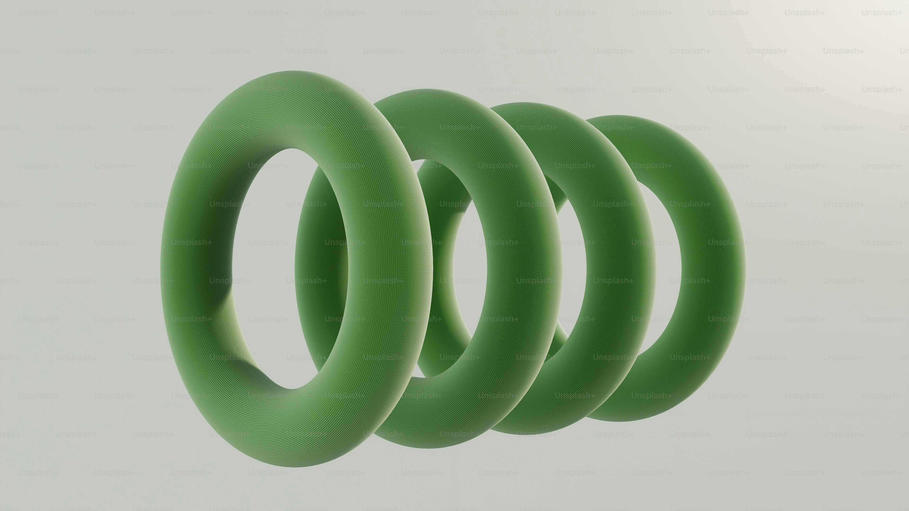 Four green torus shapes in a row