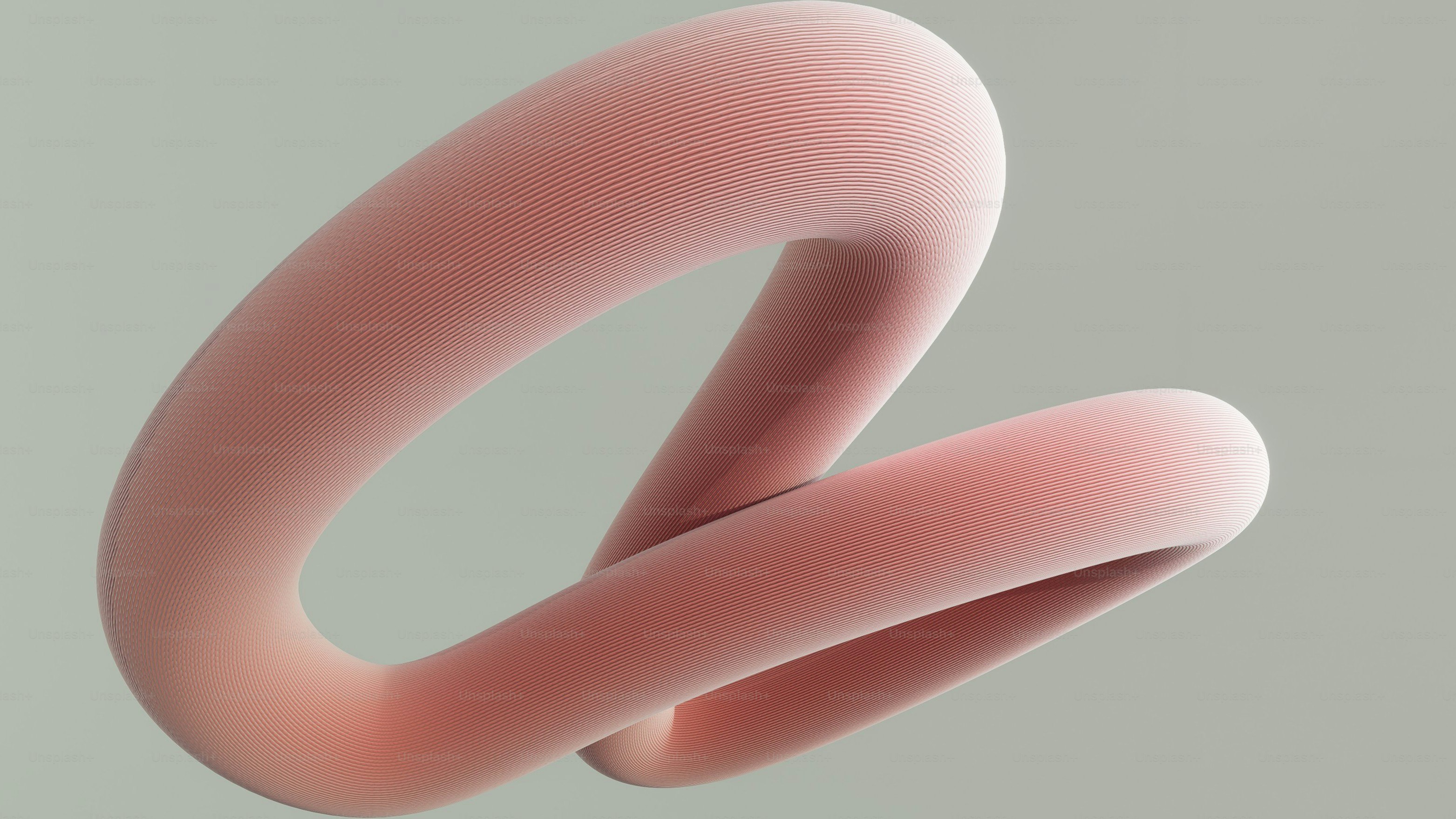 A soft pink abstract shape on a grey background