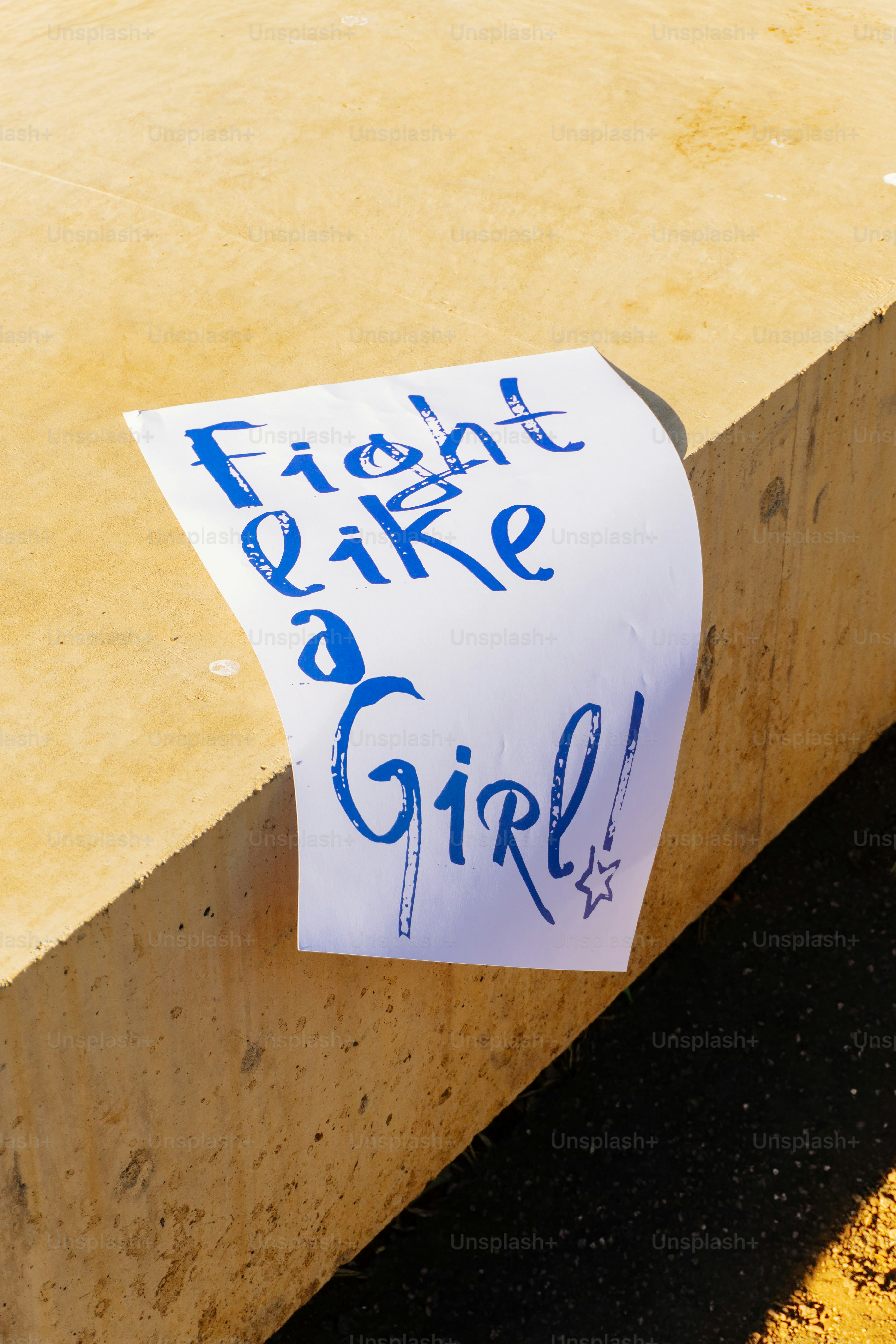 White paper with blue text "fight like a girl!"