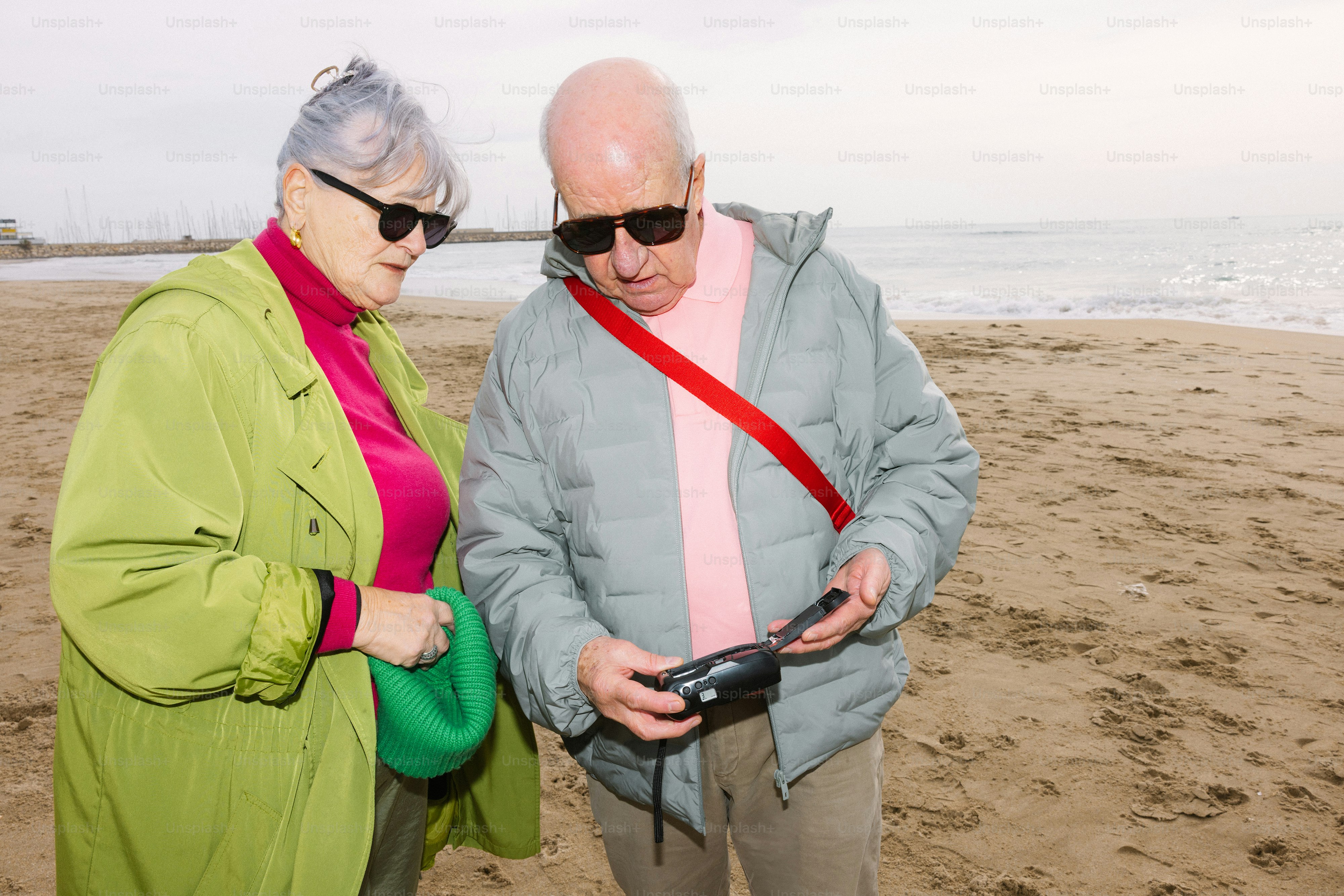 Elderly couple looking at a map by the water photo – Travel Image on ...