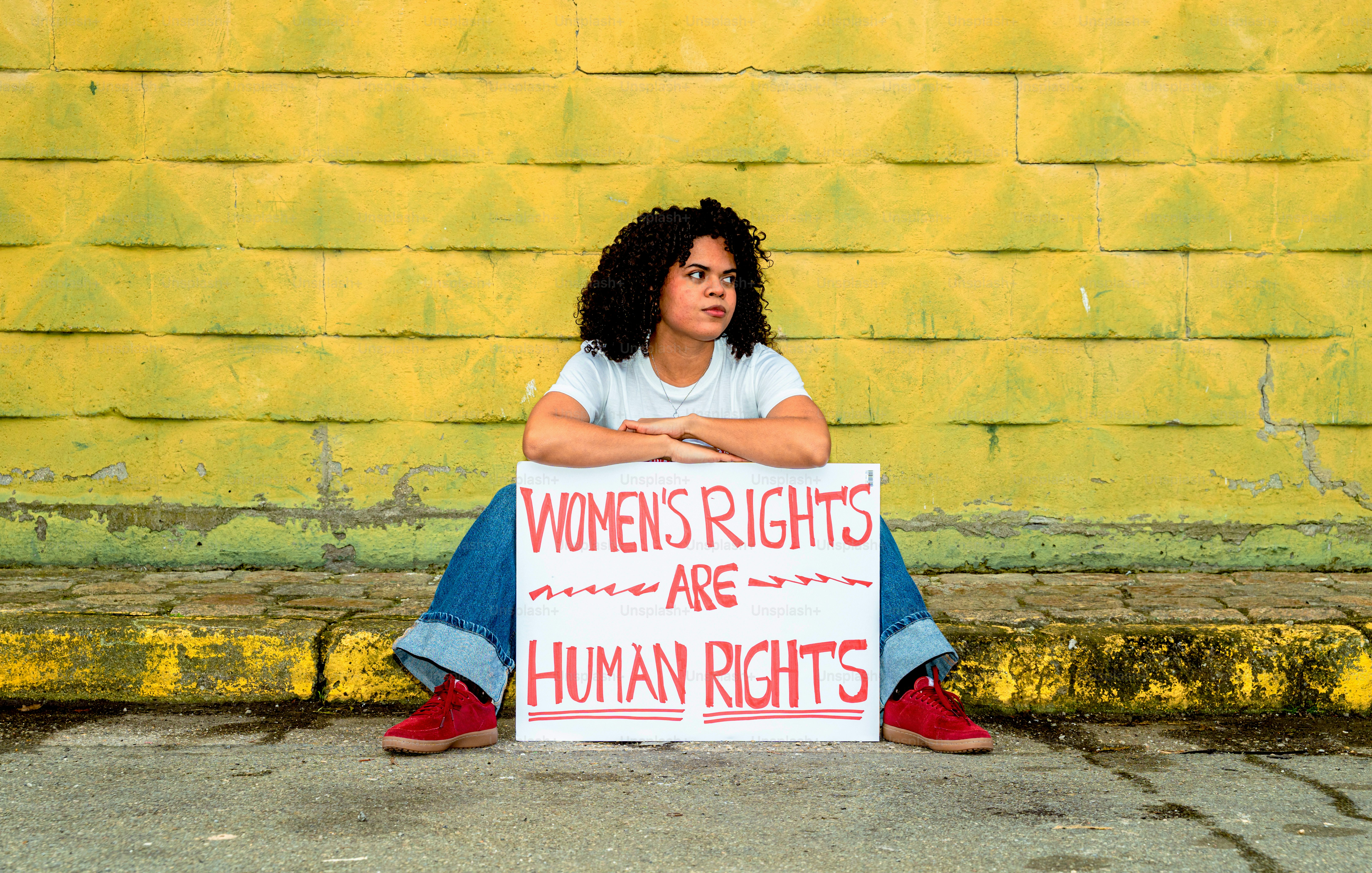 Woman holds sign stating women's rights are human rights.