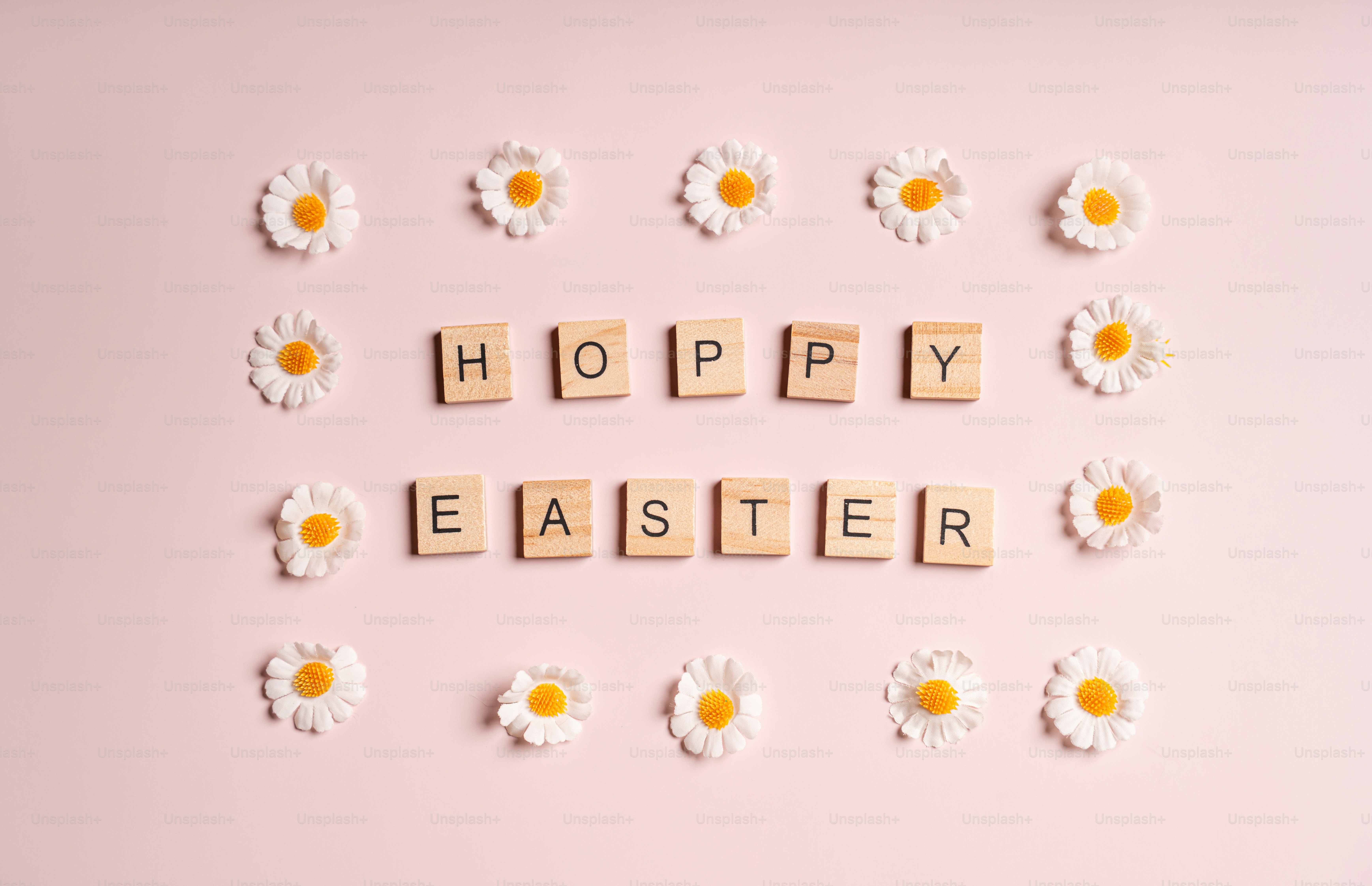 Hoppy easter spelled with wooden blocks and daisies.
