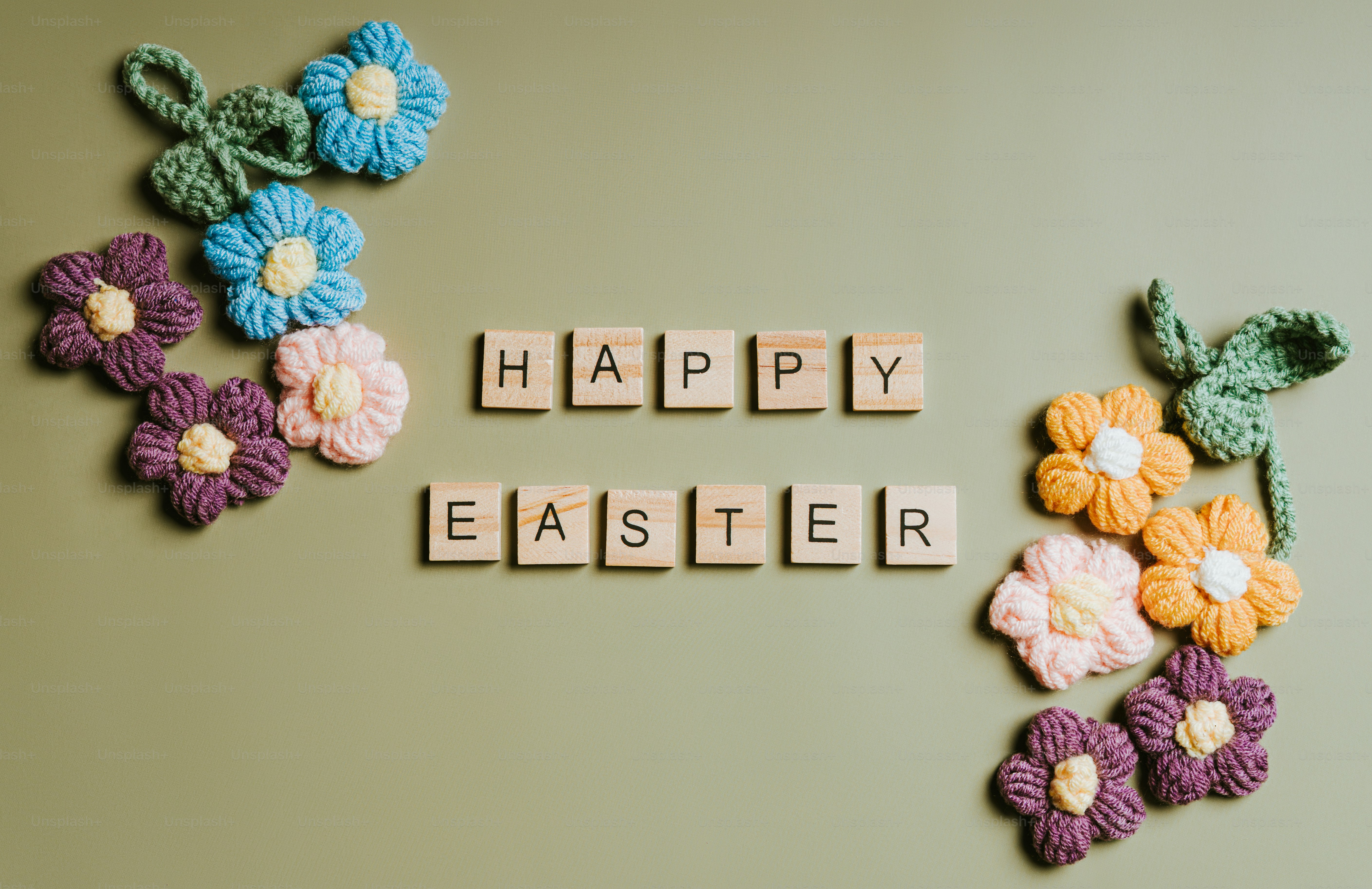 Happy easter spelled with wooden tiles and flowers