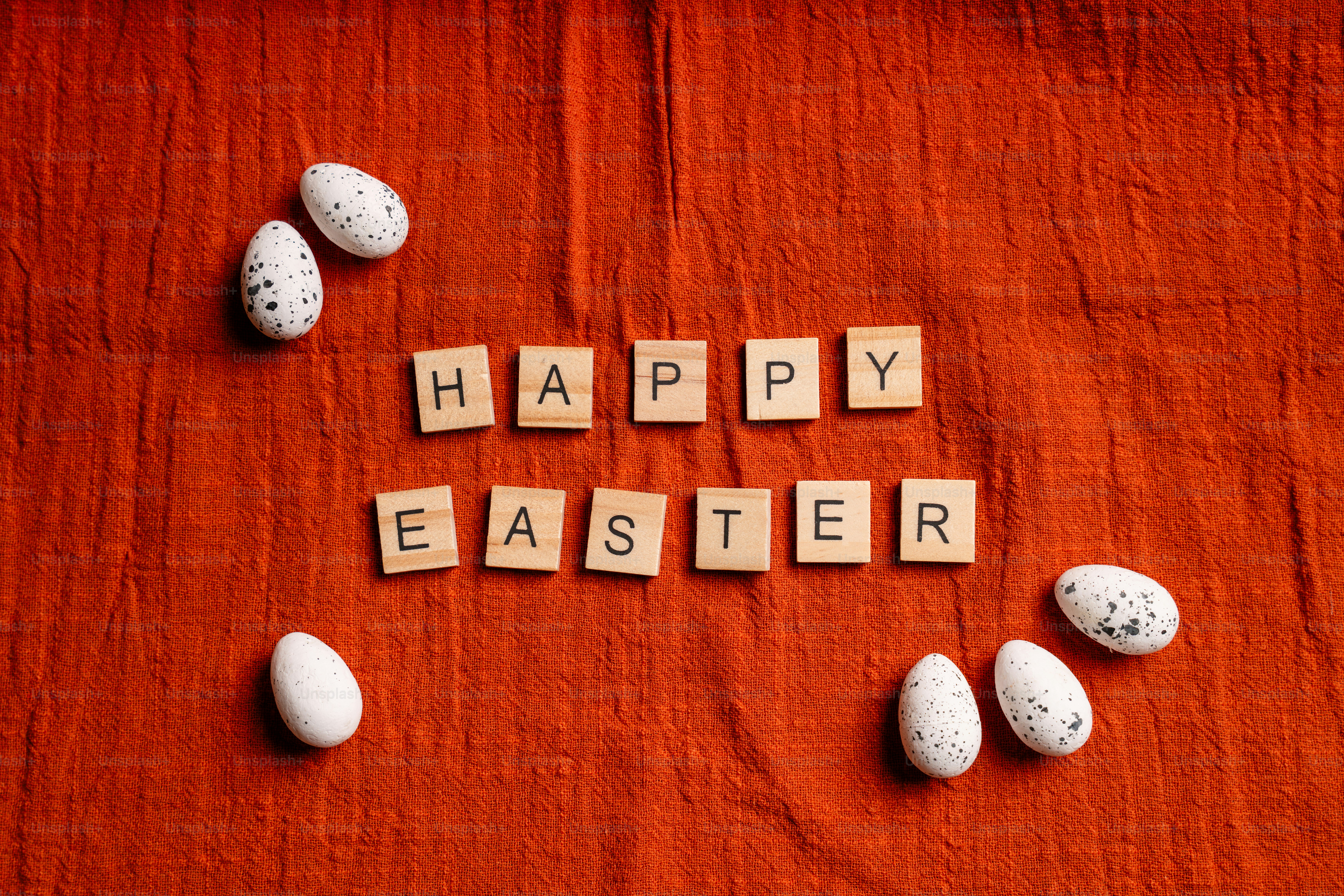 Happy easter spelled with letter tiles and eggs.