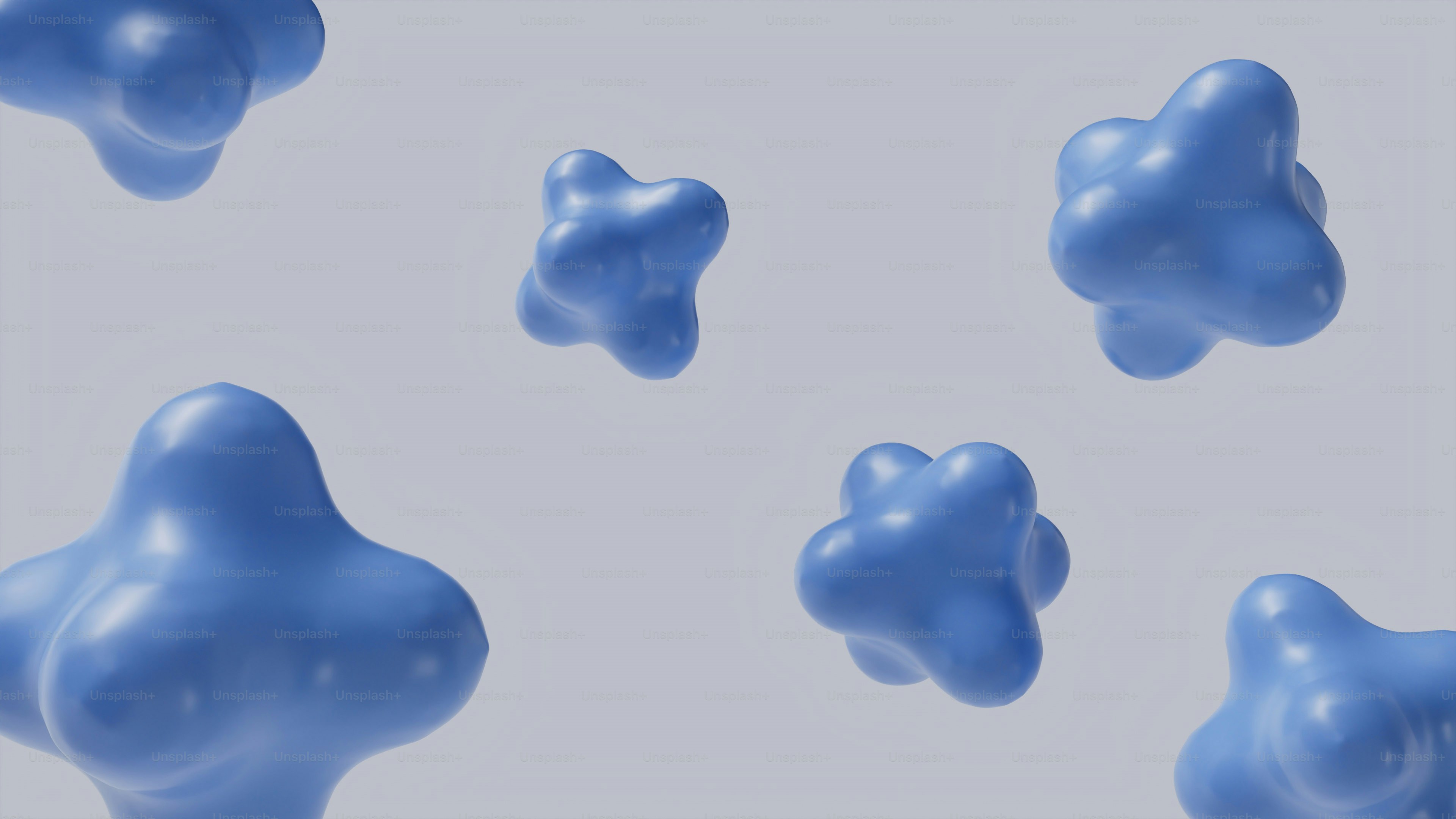 Several blue abstract shapes floating against a light background. photo ...