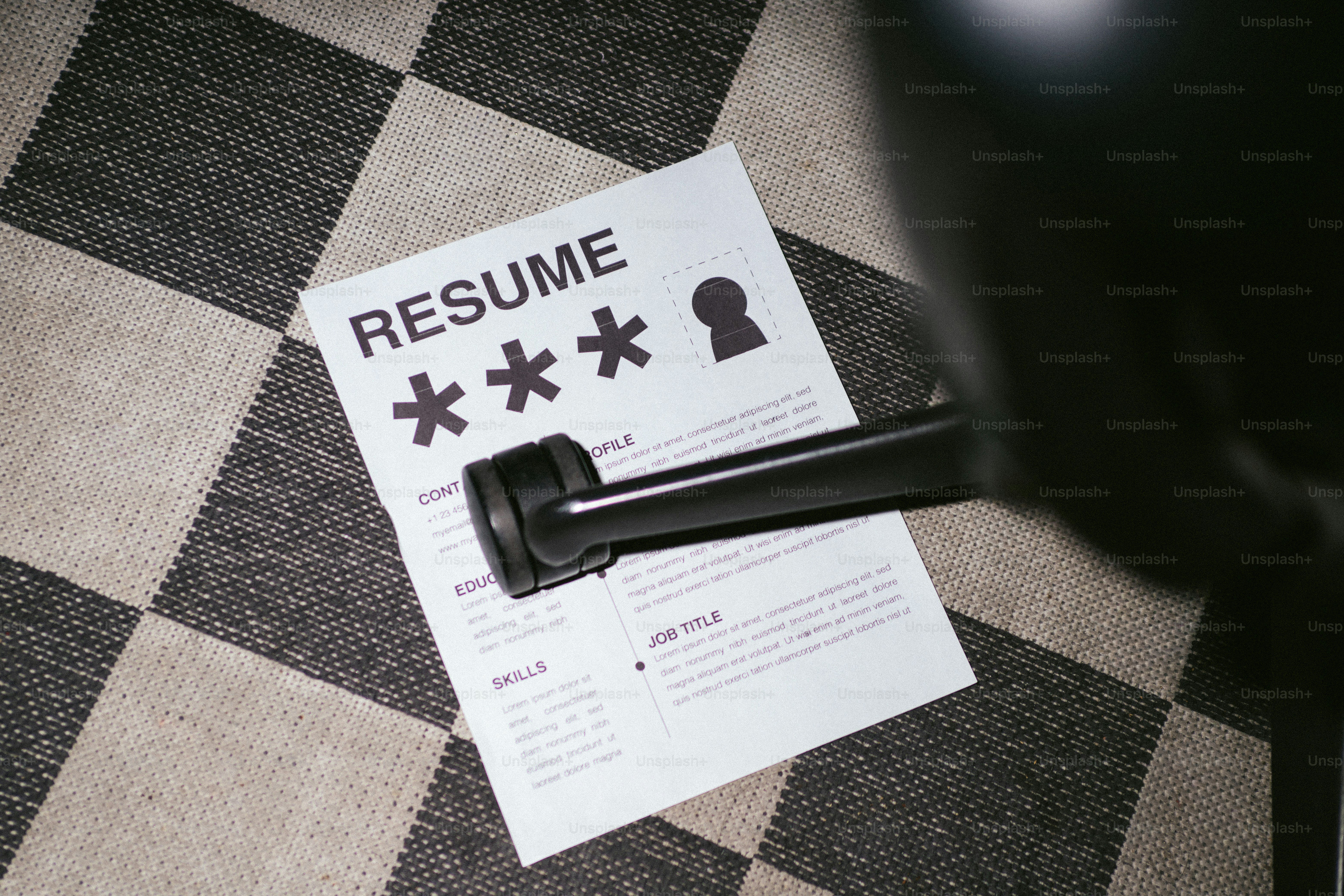 Resume with a stamp and lock symbol on checkered floor