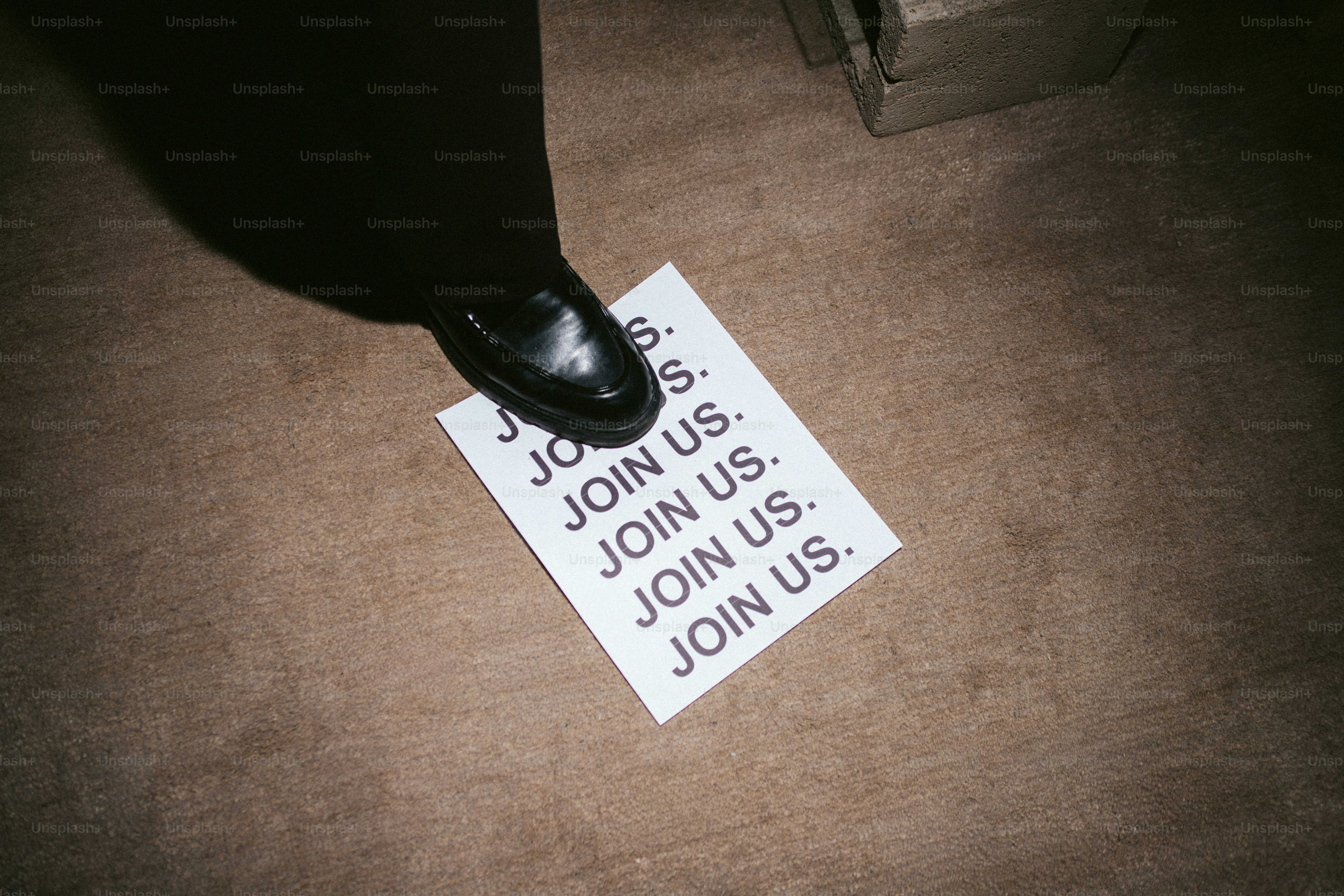 A shoe stepping on a paper that says join us. photo – Business Image on ...