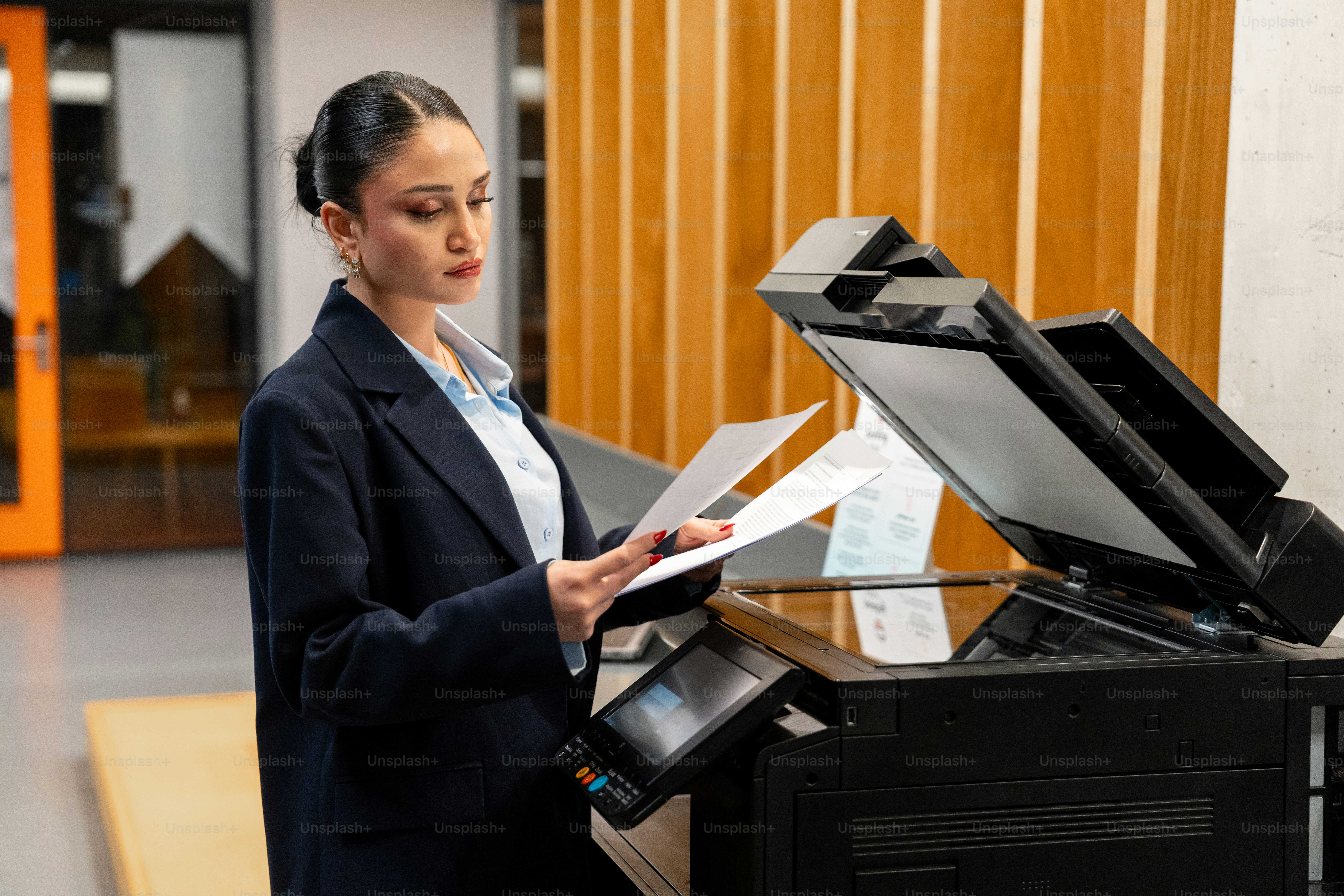 A woman in a suit using a copy machine photo – Business meeting Image ...