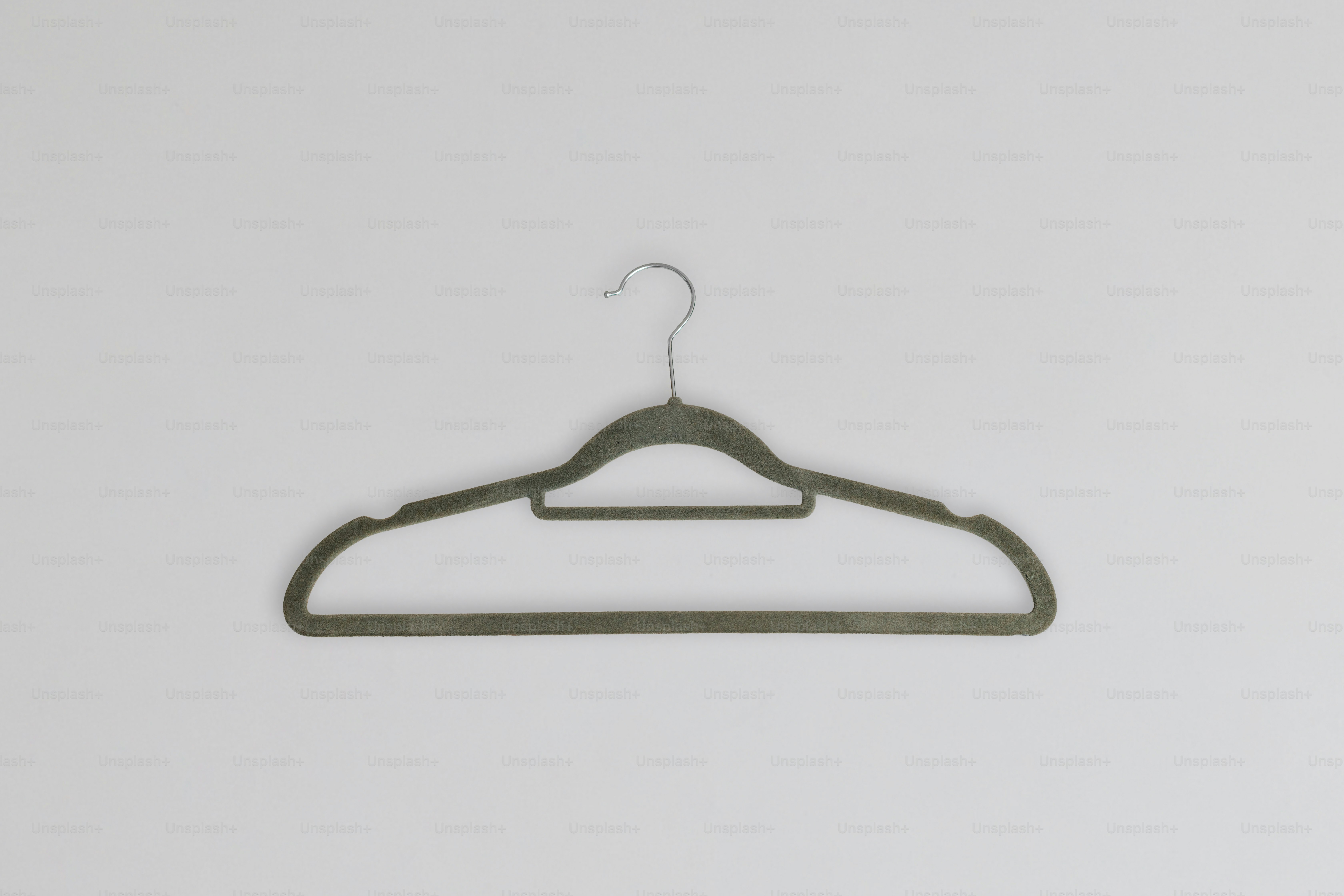 A single gray clothes hanger on a white background
