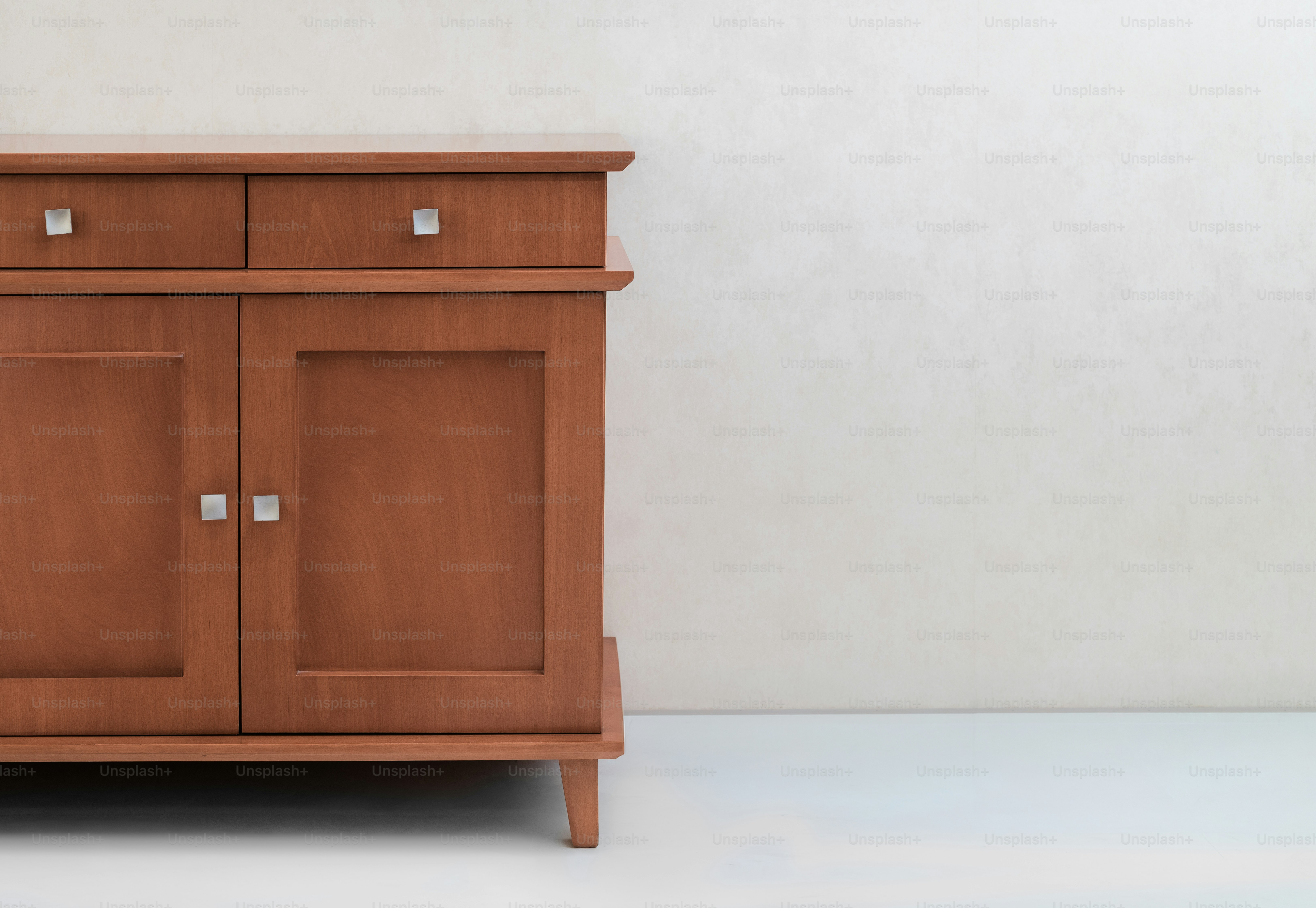 A wooden cabinet with two drawers and two doors.