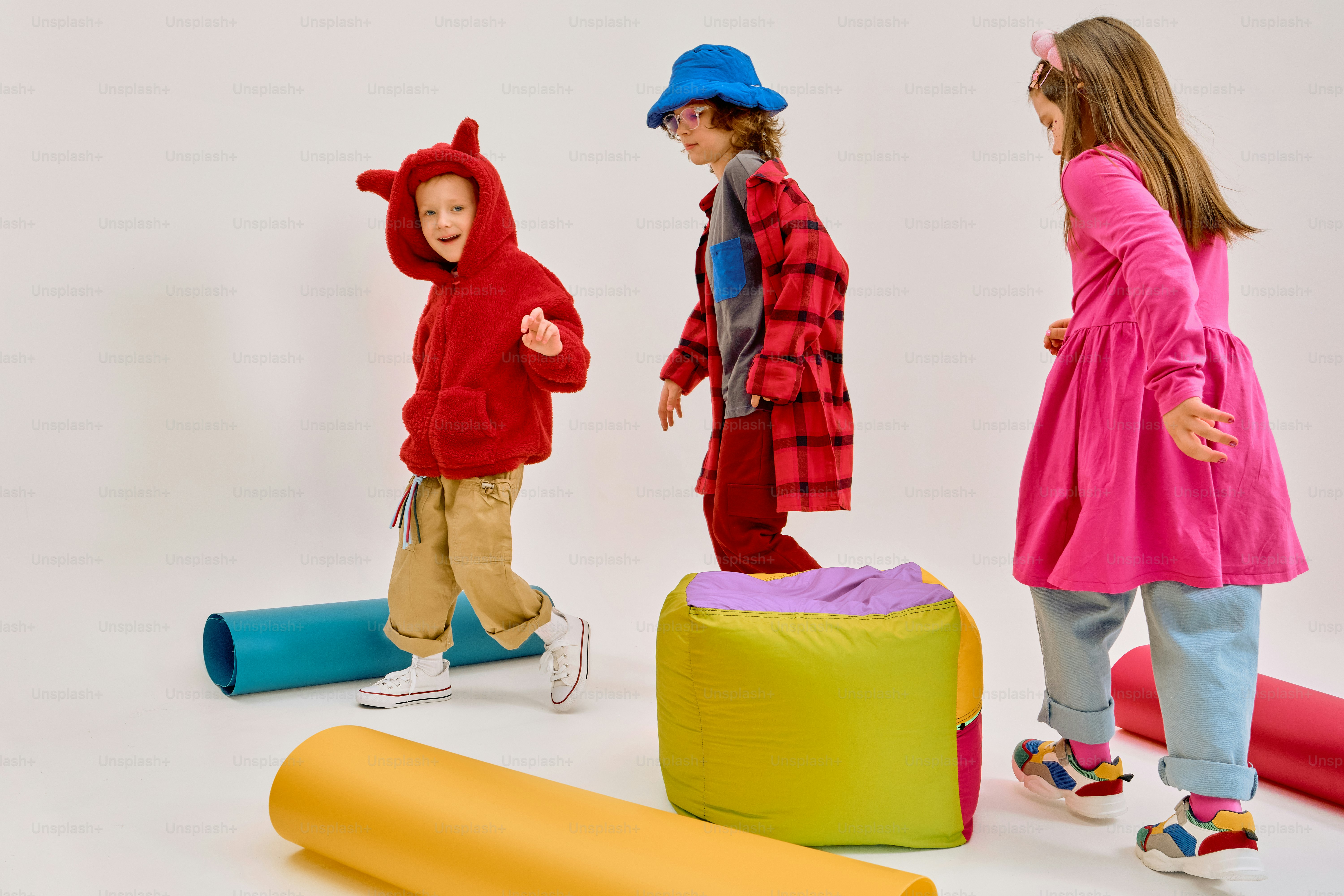 Children in costumes playing with colorful props photo – Running Image ...