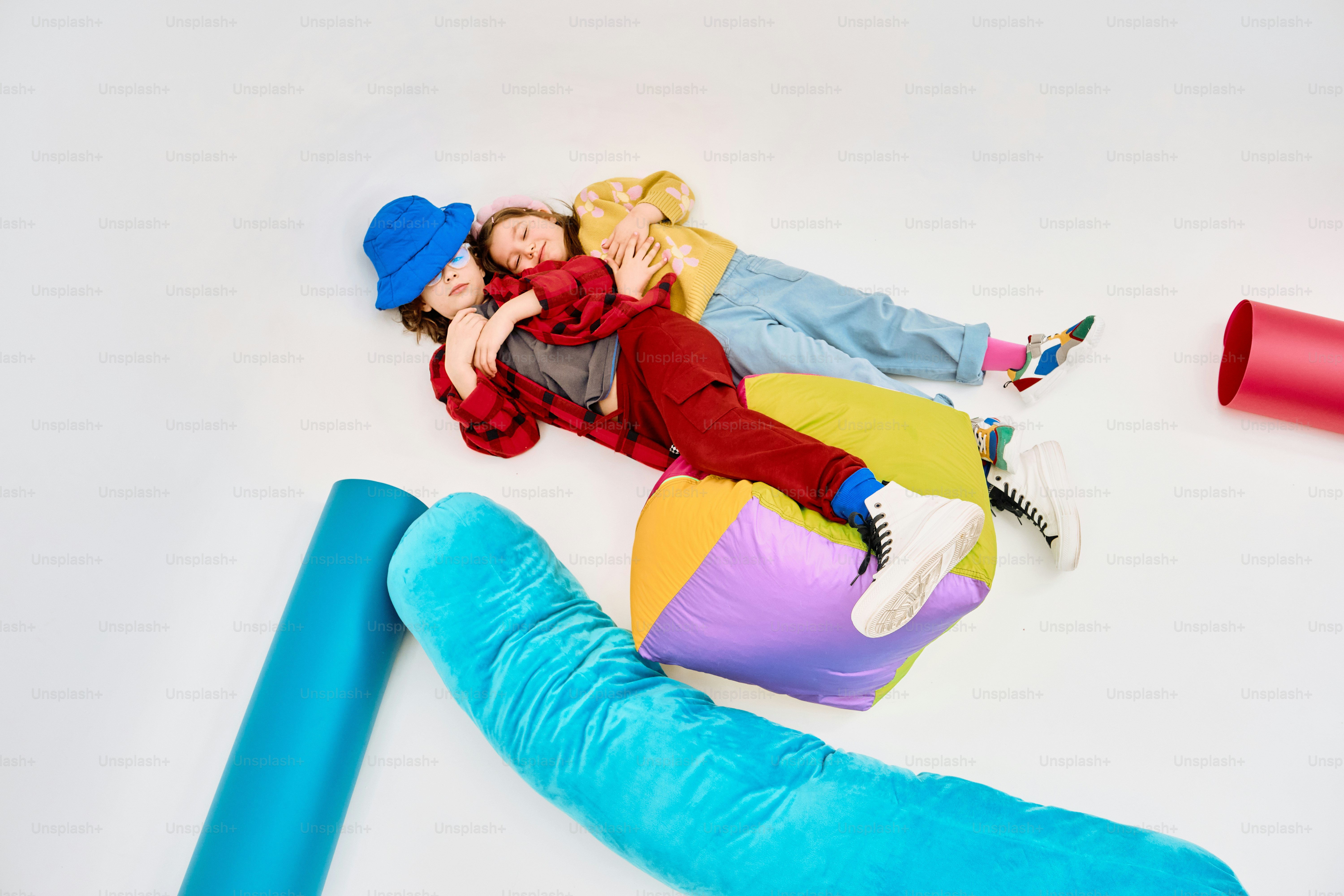 Two people resting on colorful cushions and tubes. photo – Fashion ...