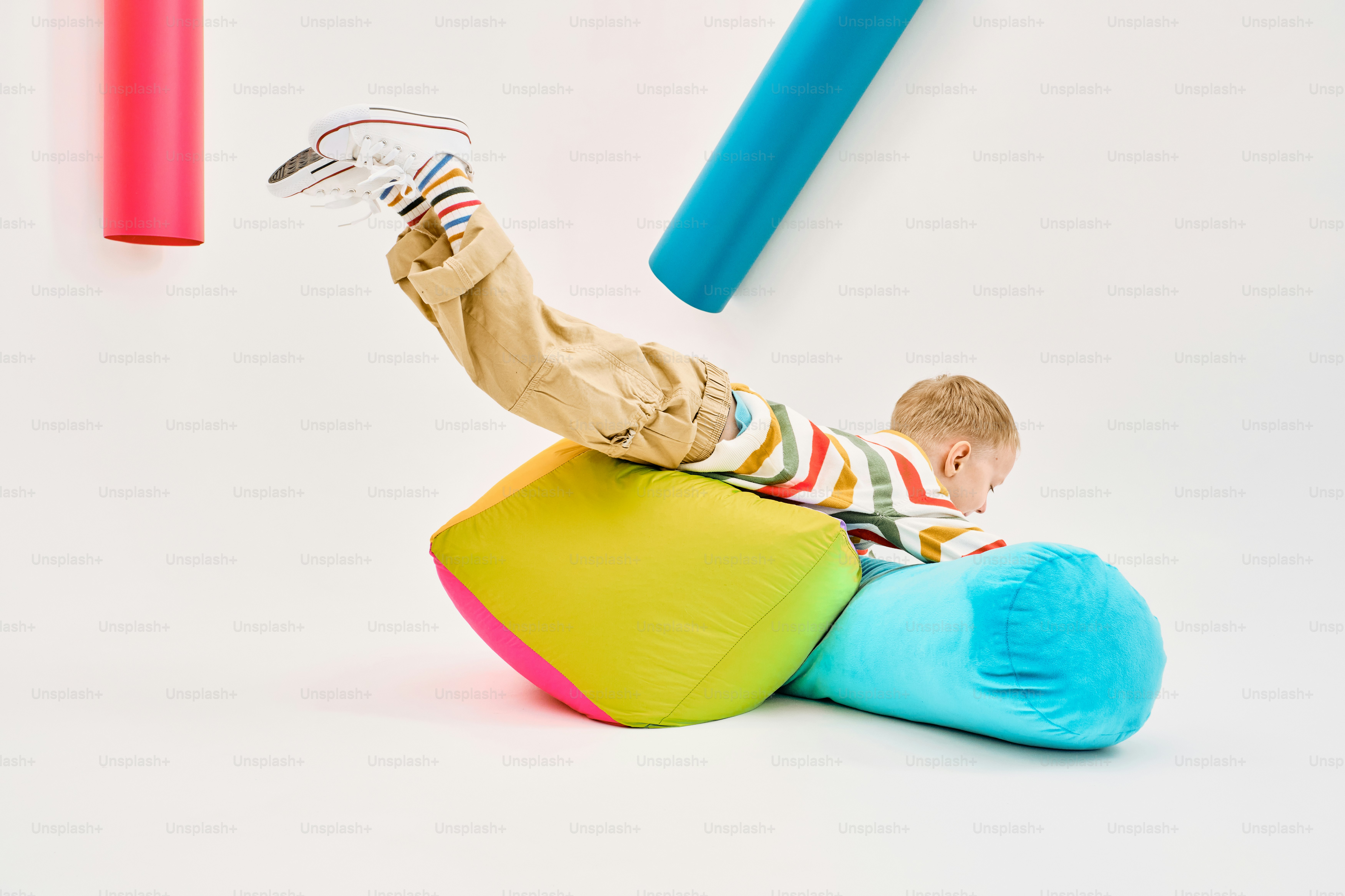 Child playing on colorful soft blocks