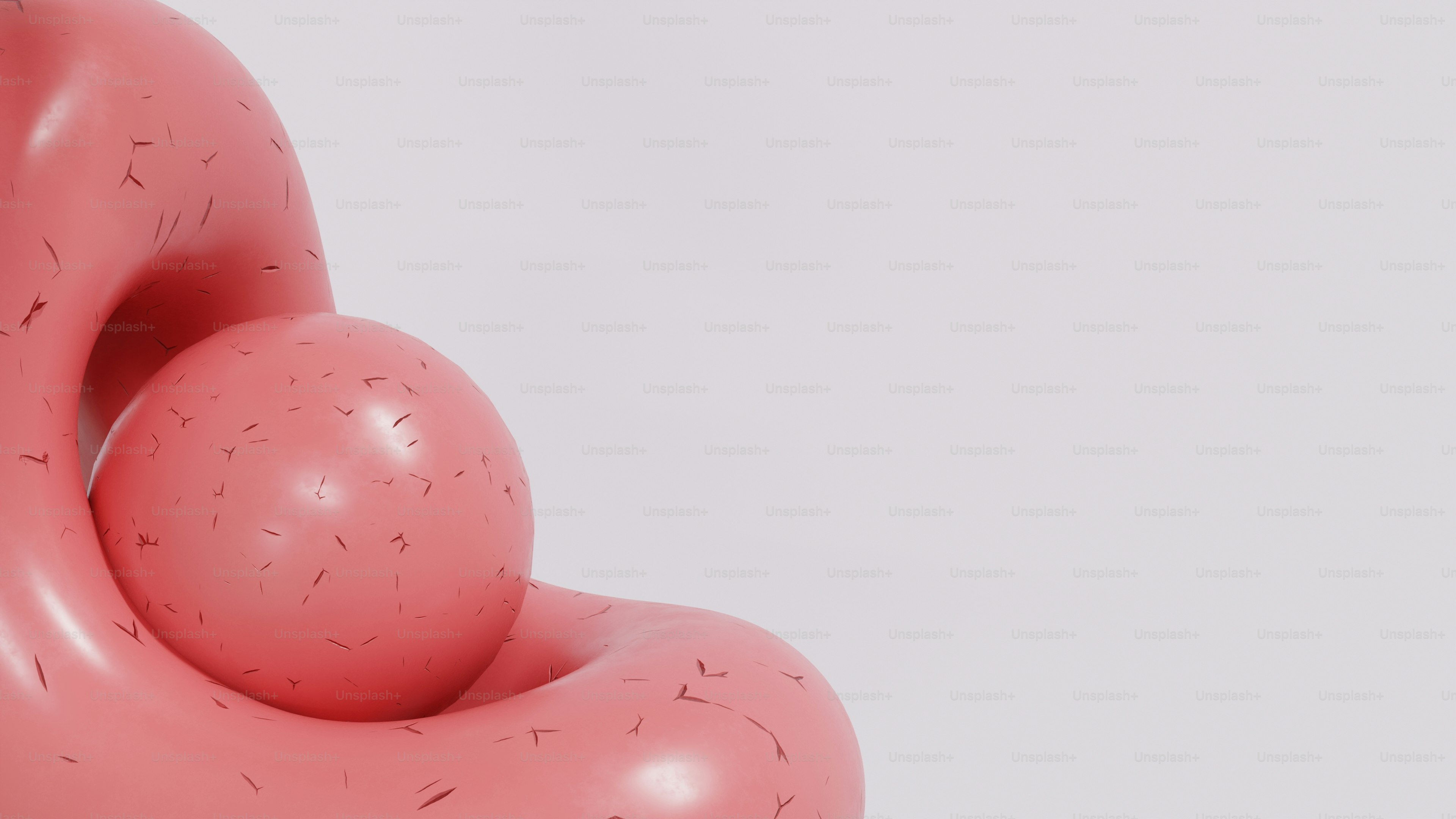 滑らかで抽象的な形に収まったピンクの球体。