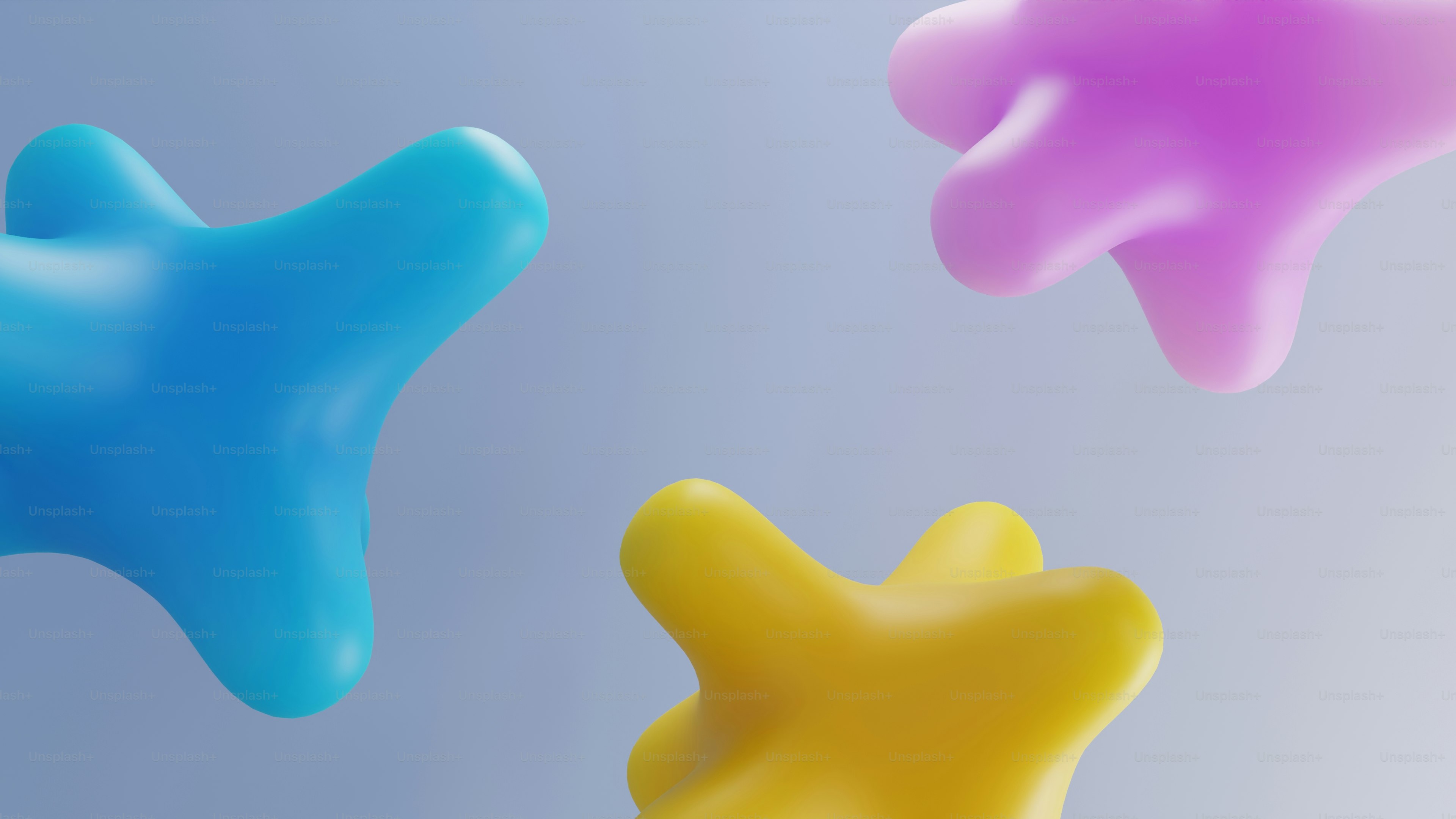 Trois formes abstraites, en forme de taches, en bleu, jaune et rose.