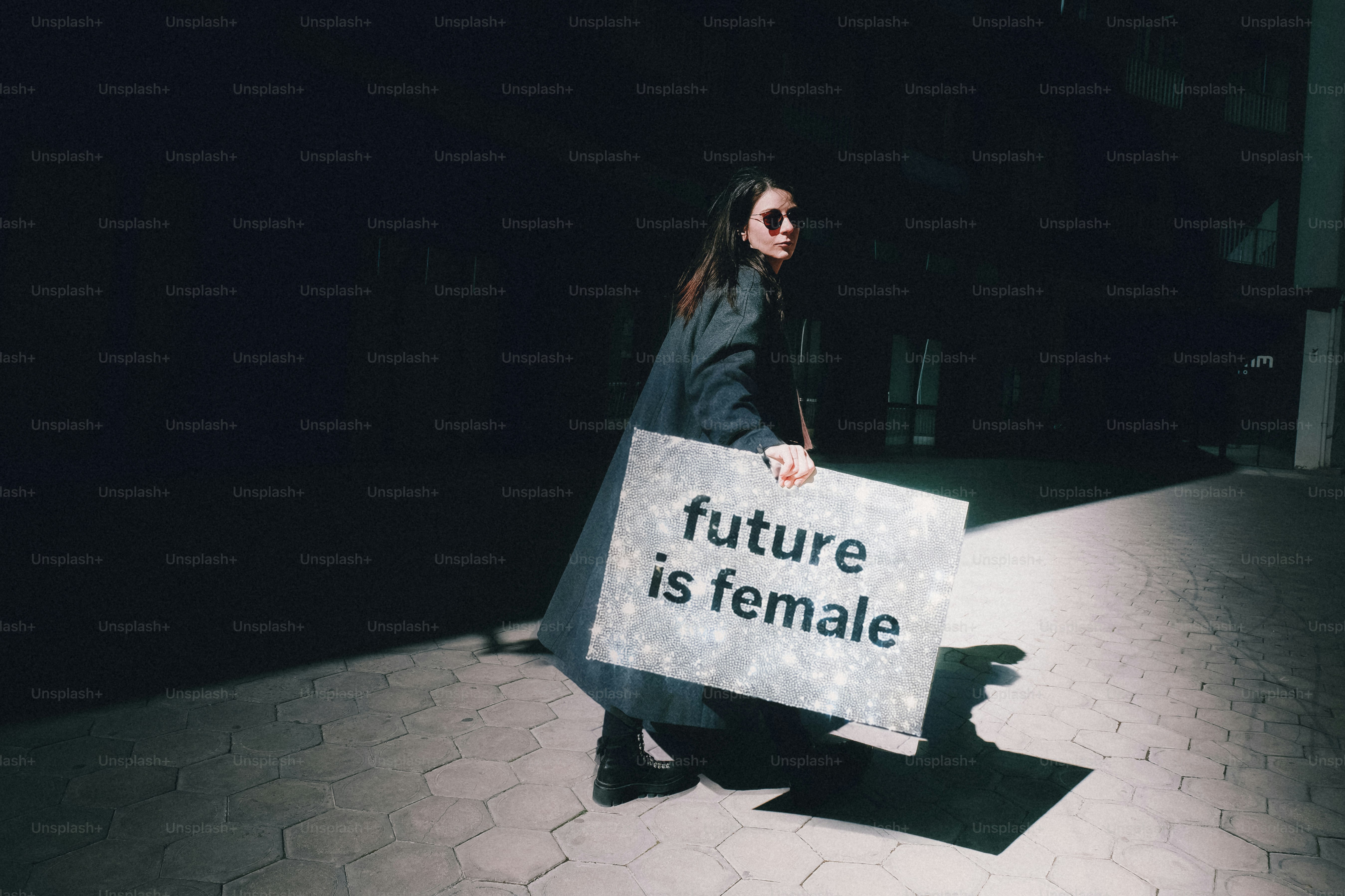 Woman holding a sign that says "future is female"