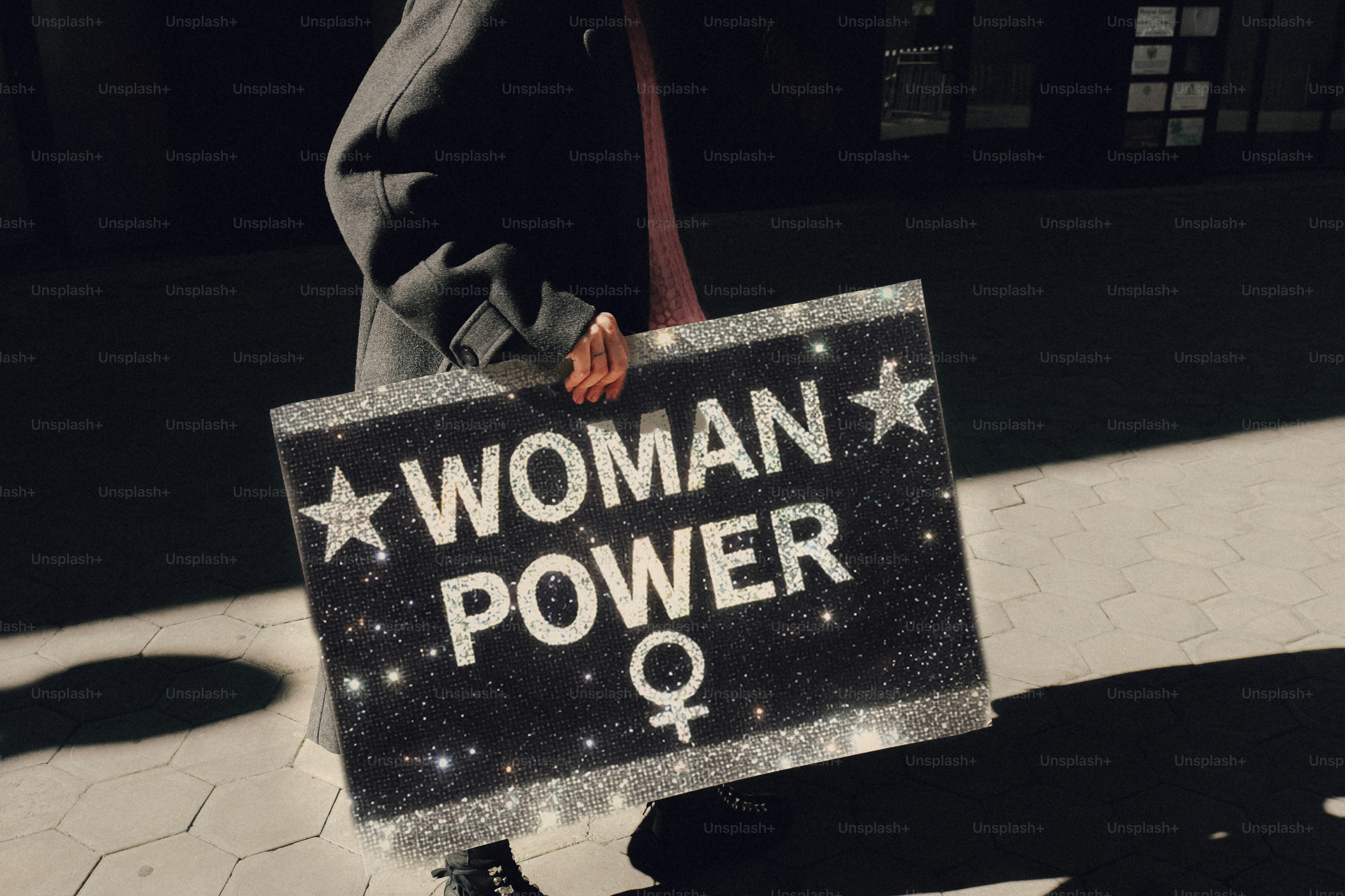 Woman holding a "woman power" sign.