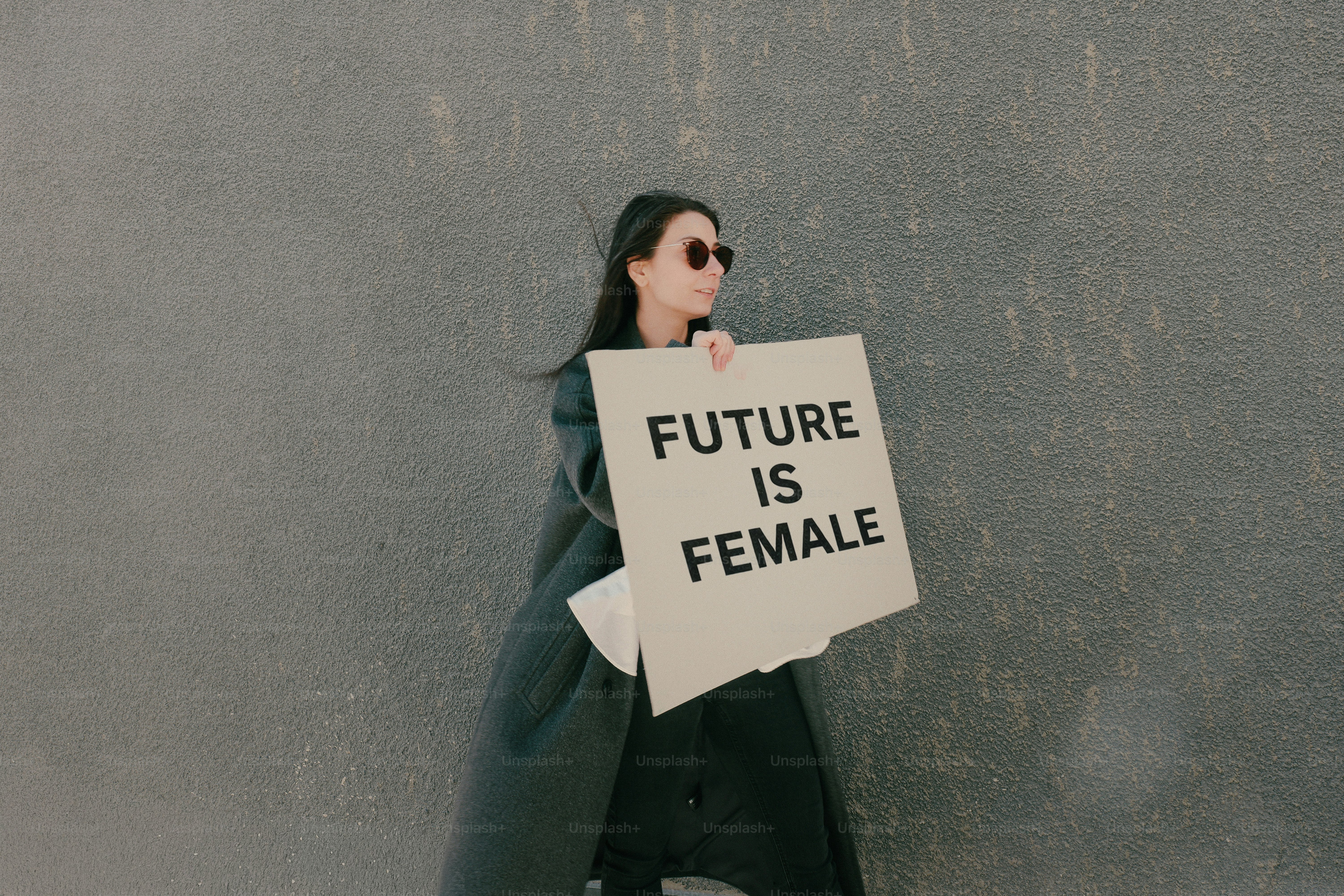 Woman holding a sign that says future is female