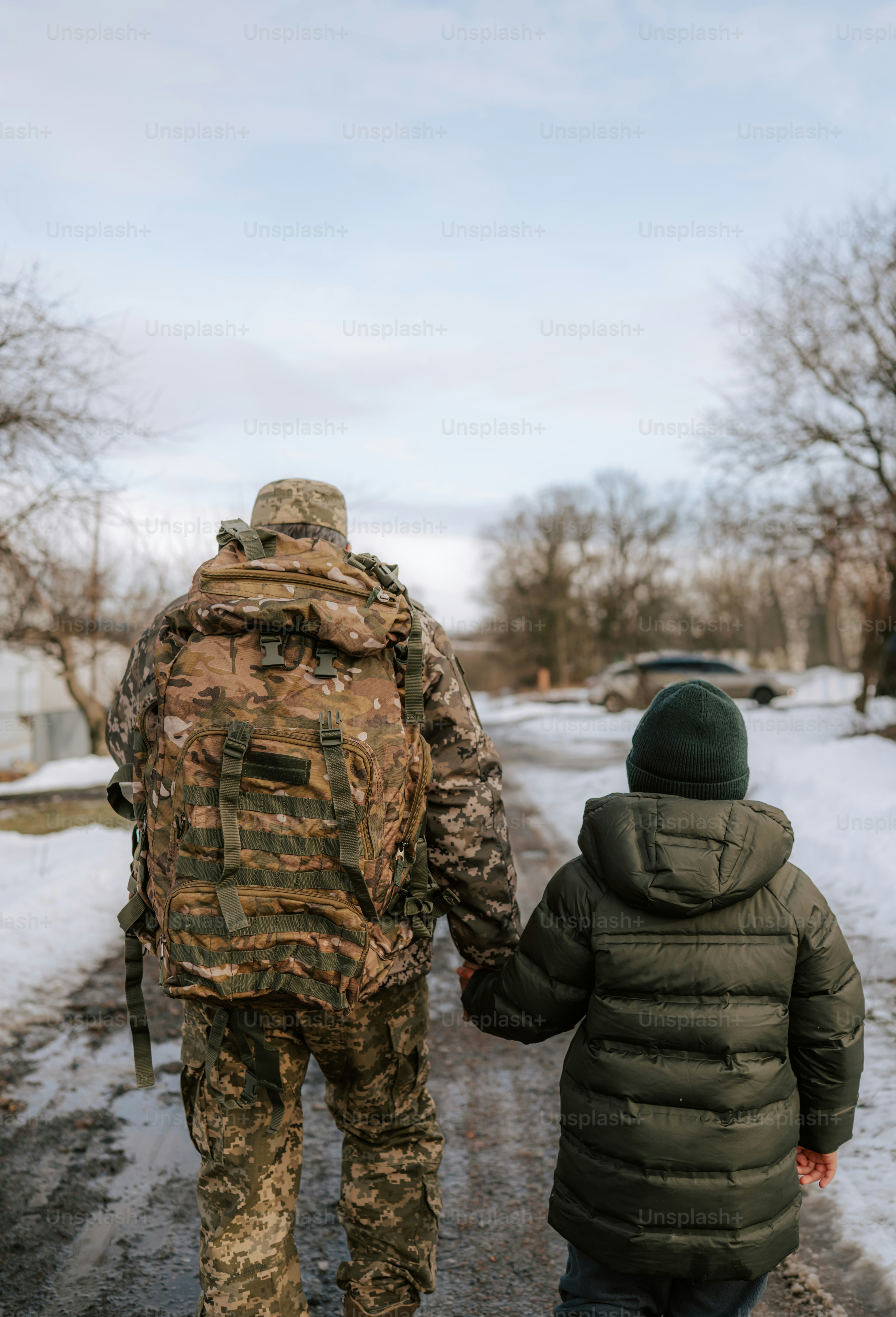 Soldier and child shake hands in front of building. photo – Handshake ...