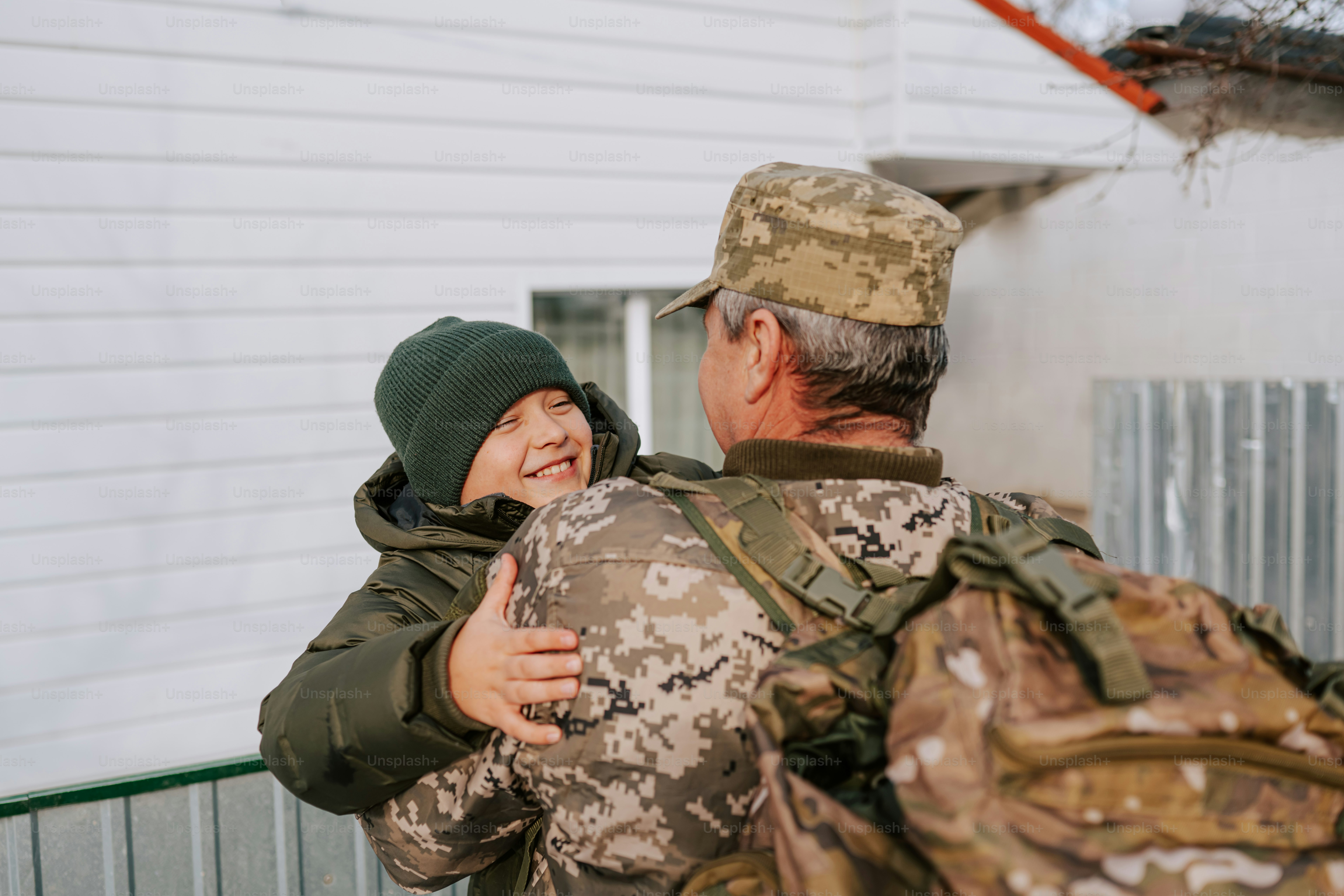 Soldier hugging a happy child outside photo – Family Image on Unsplash