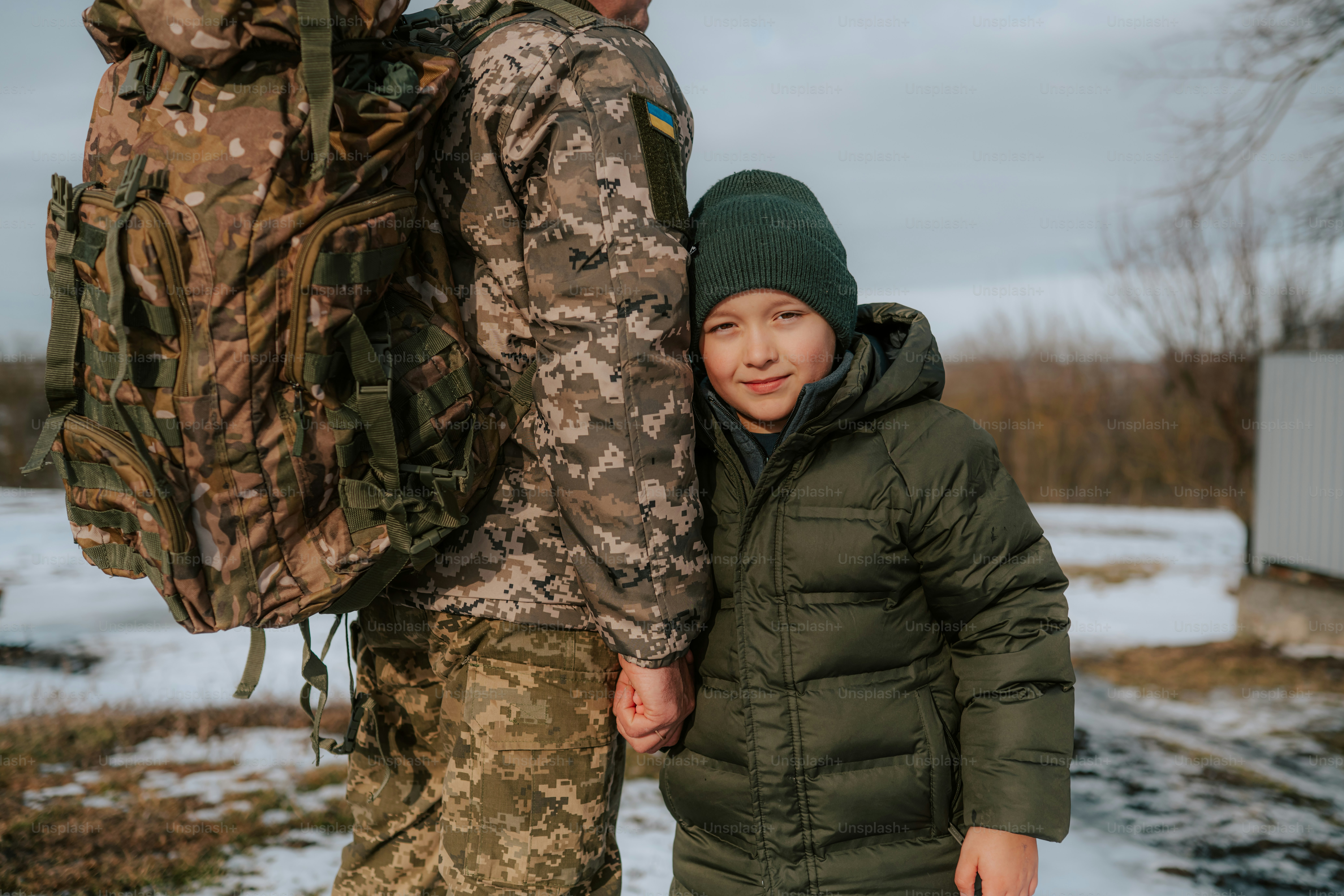 Soldier with large backpack holds child's hand. photo – Family Image on ...