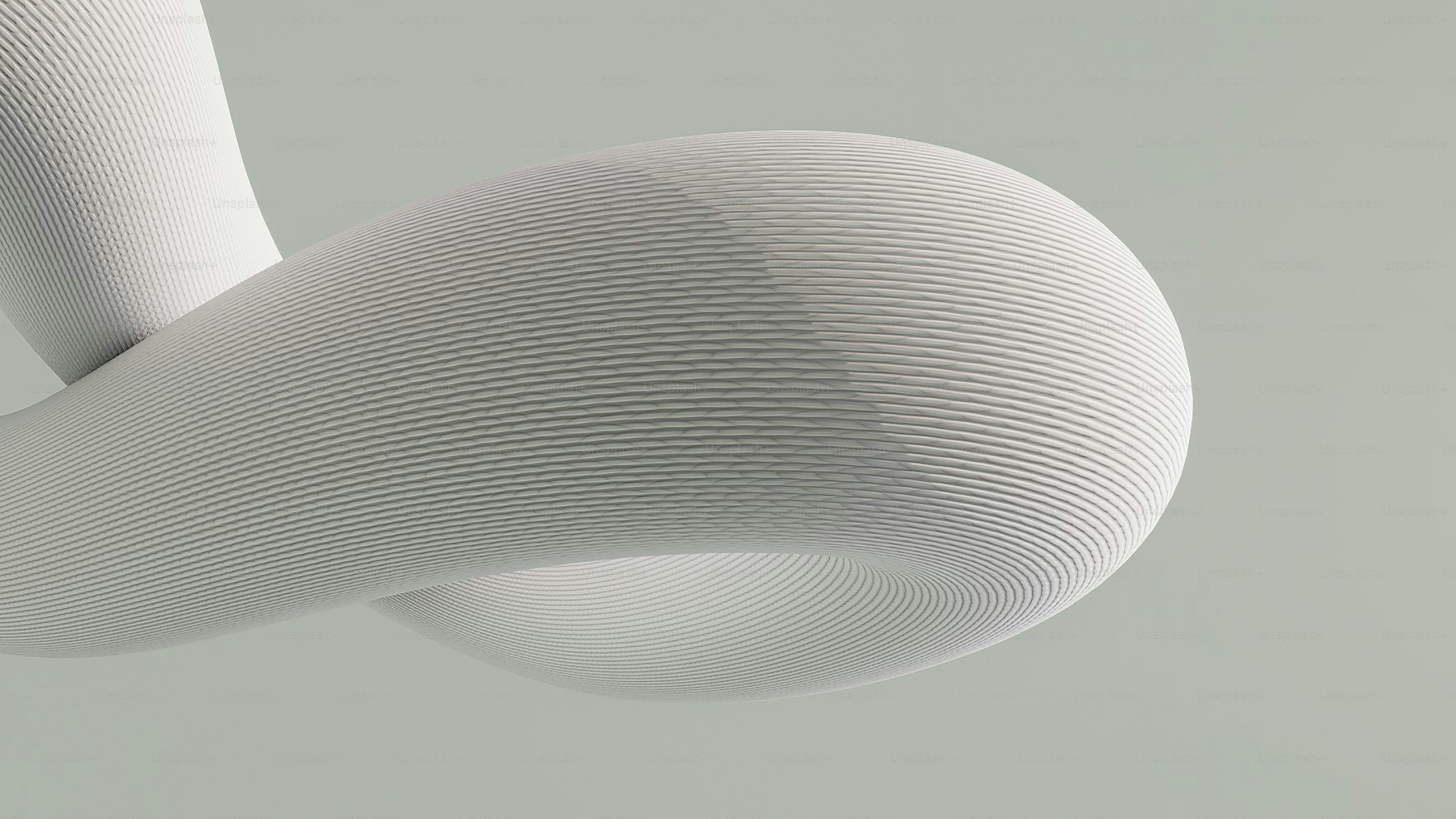 Abstract white sculpture with textured surface.