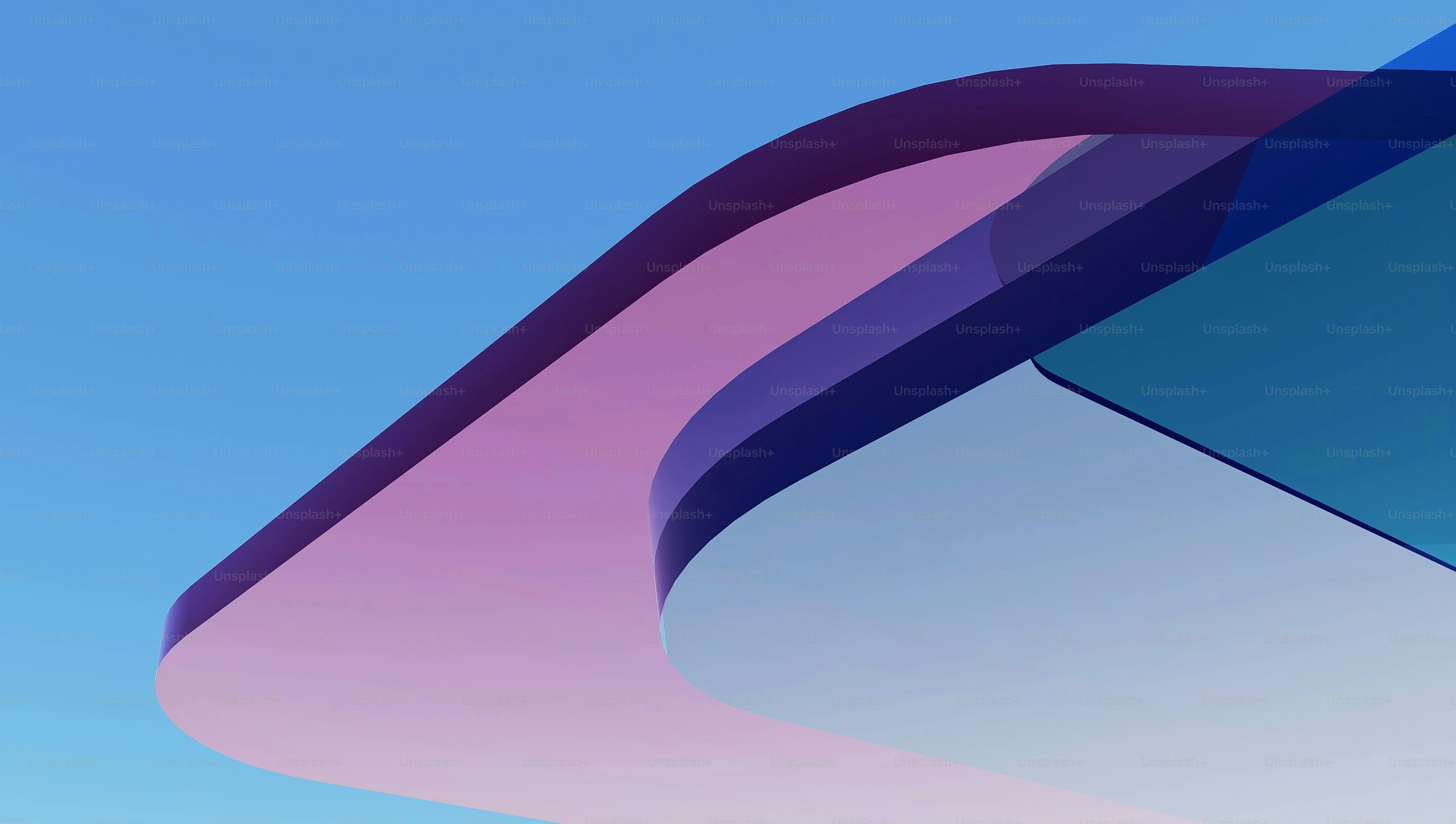 Abstract wavy shapes in pink and blue against sky