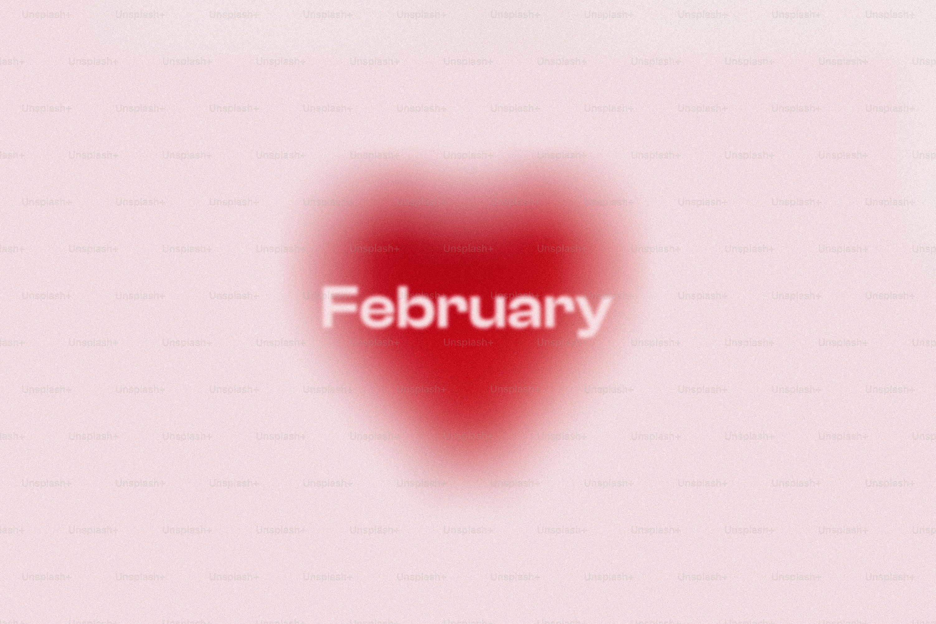 A blurred red heart with the word february