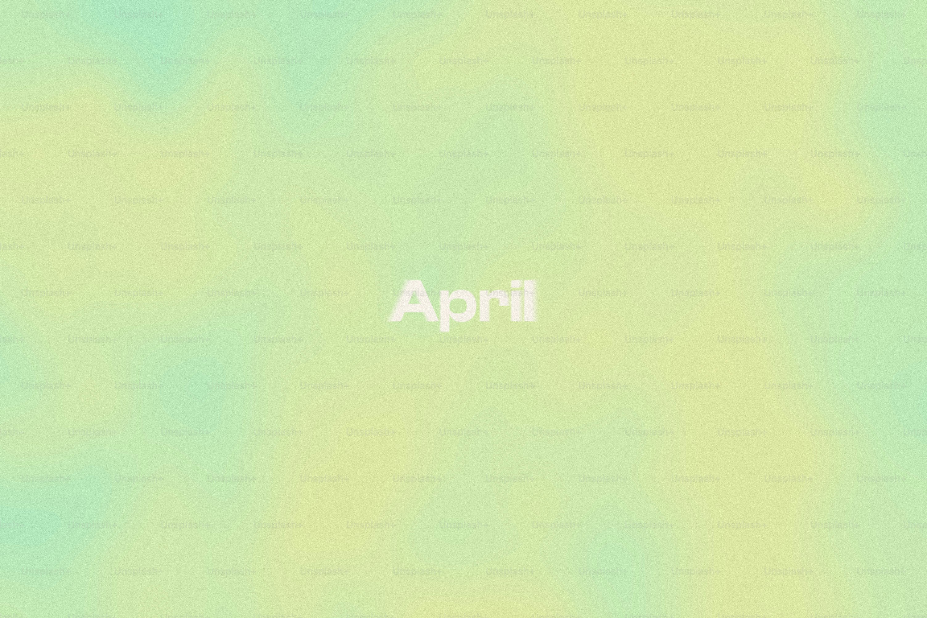 The word april on a soft pastel background