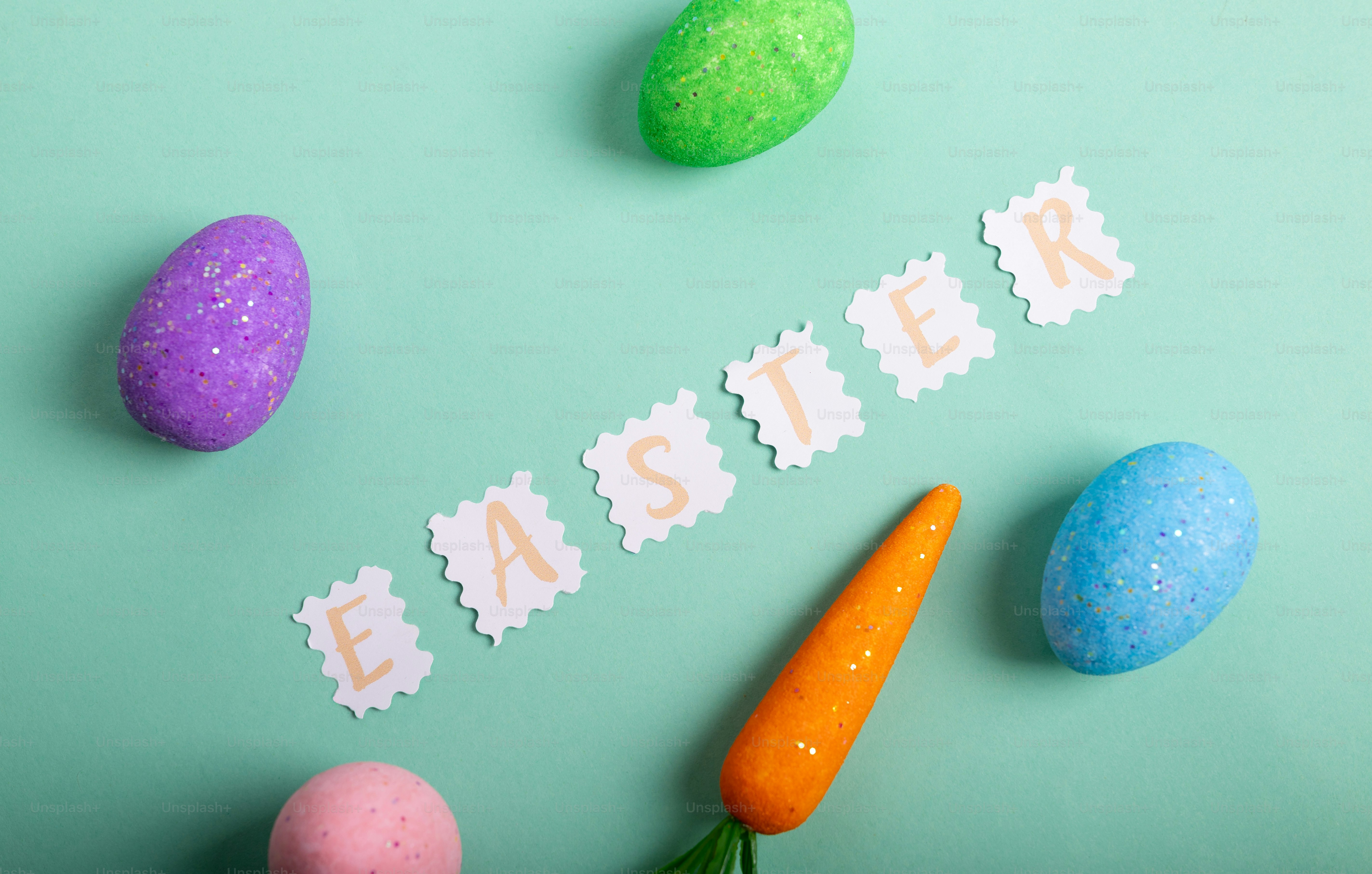 Huevos de Pascua y zanahoria sobre un fondo pastel