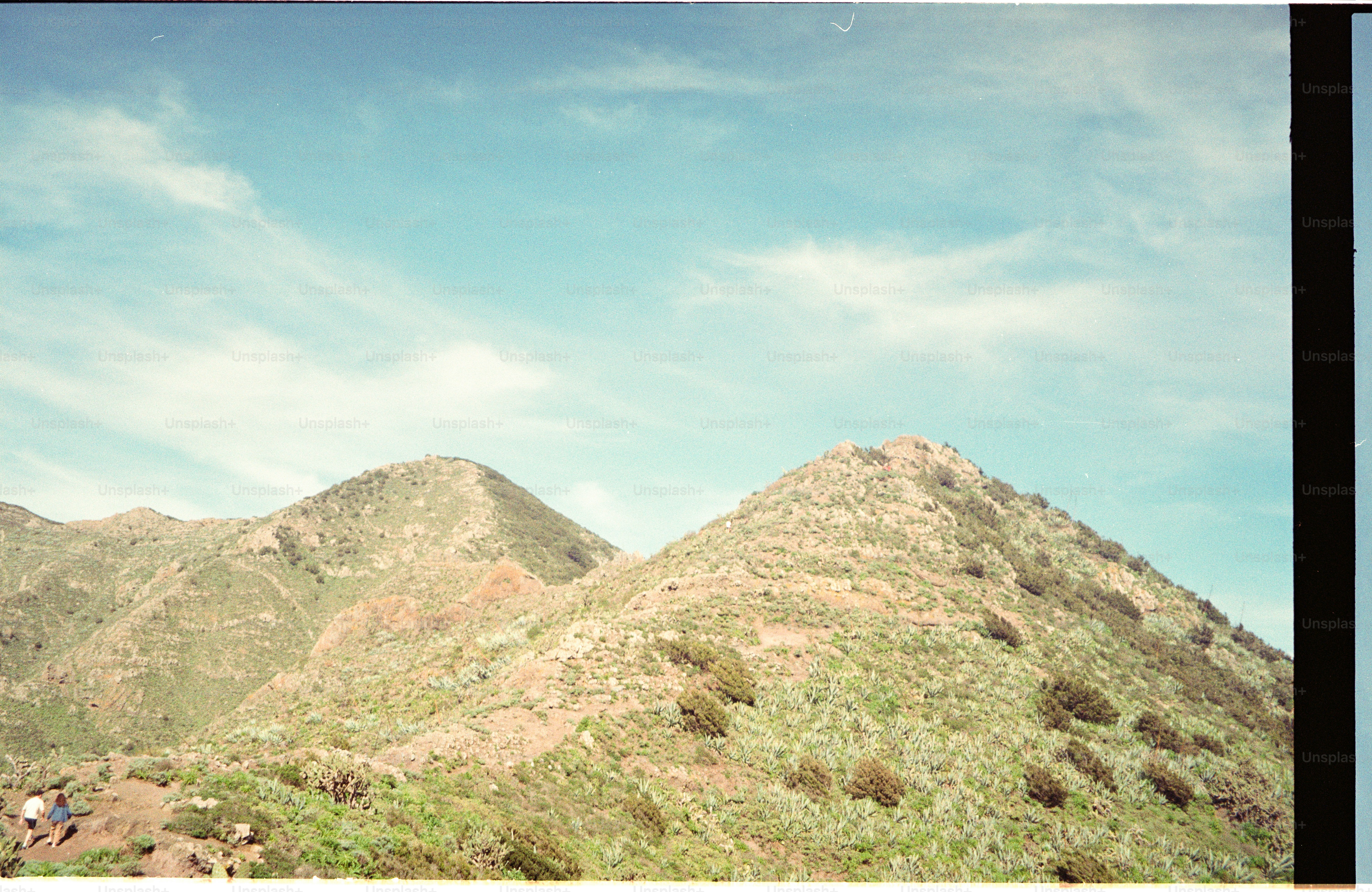 Green hills under a cloudy blue sky photo – Travel Image on Unsplash