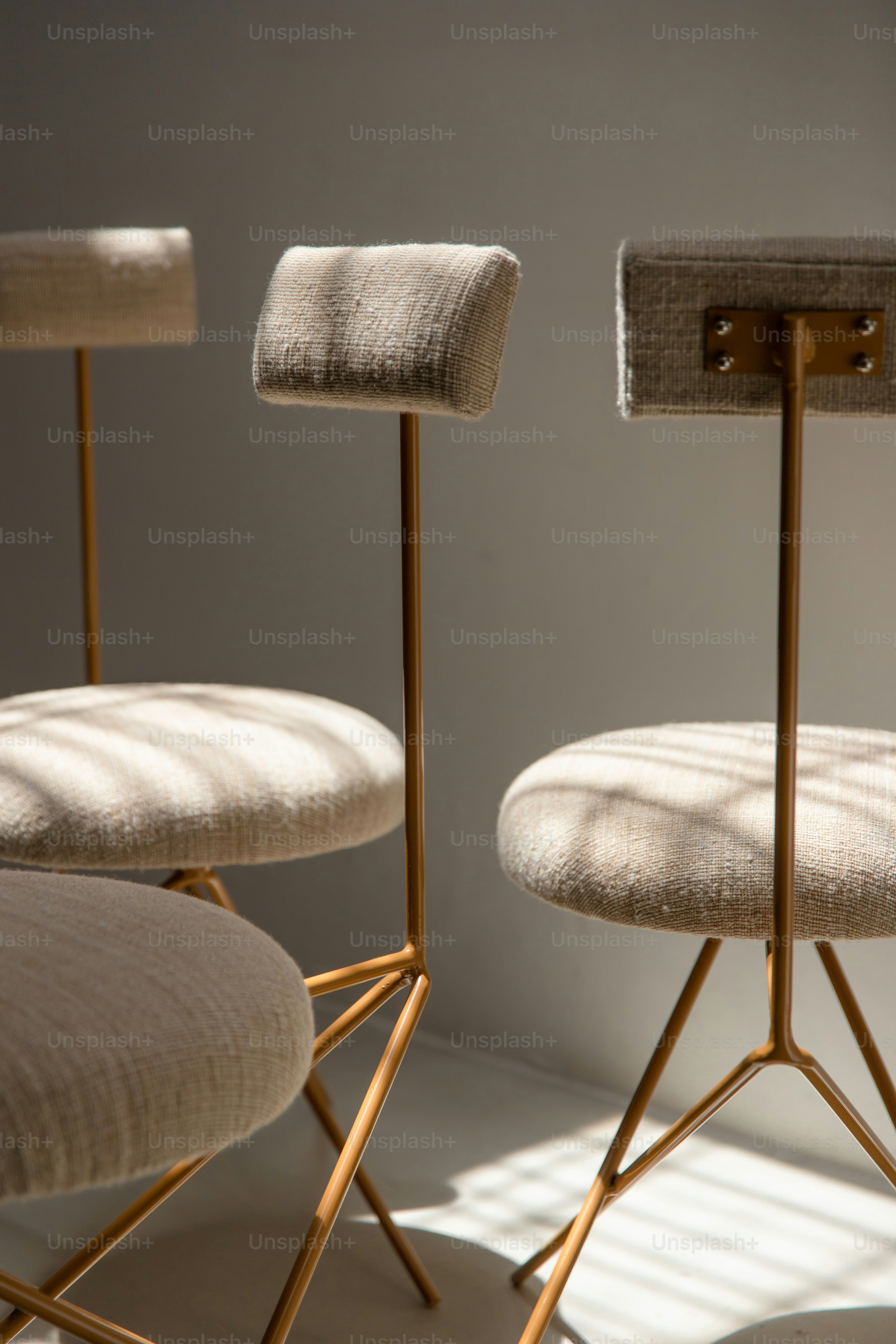 Three modern chairs with light-colored upholstery and thin legs. photo ...