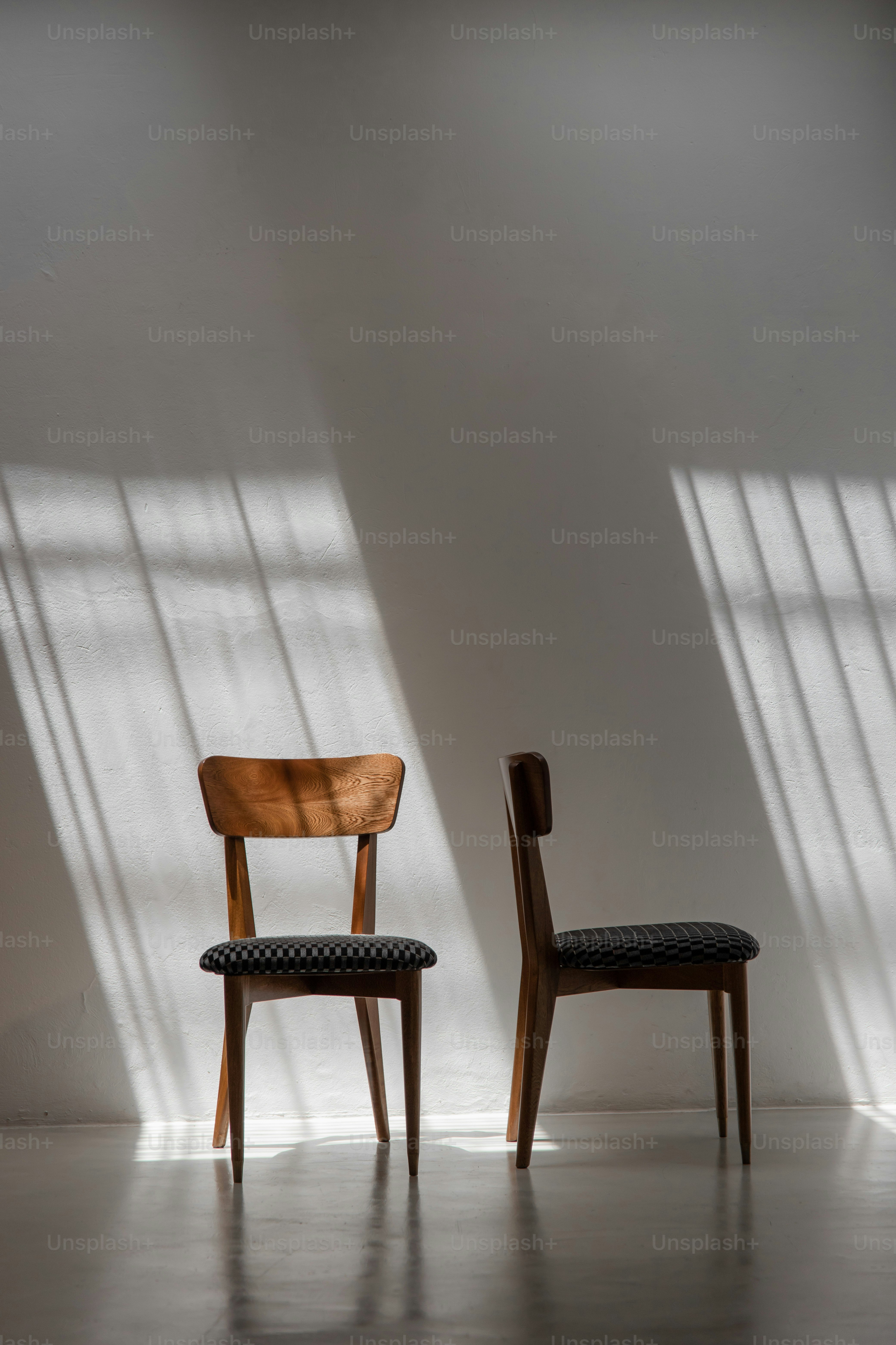 Two wooden chairs with patterned seats in sunlight photo – Architecture ...