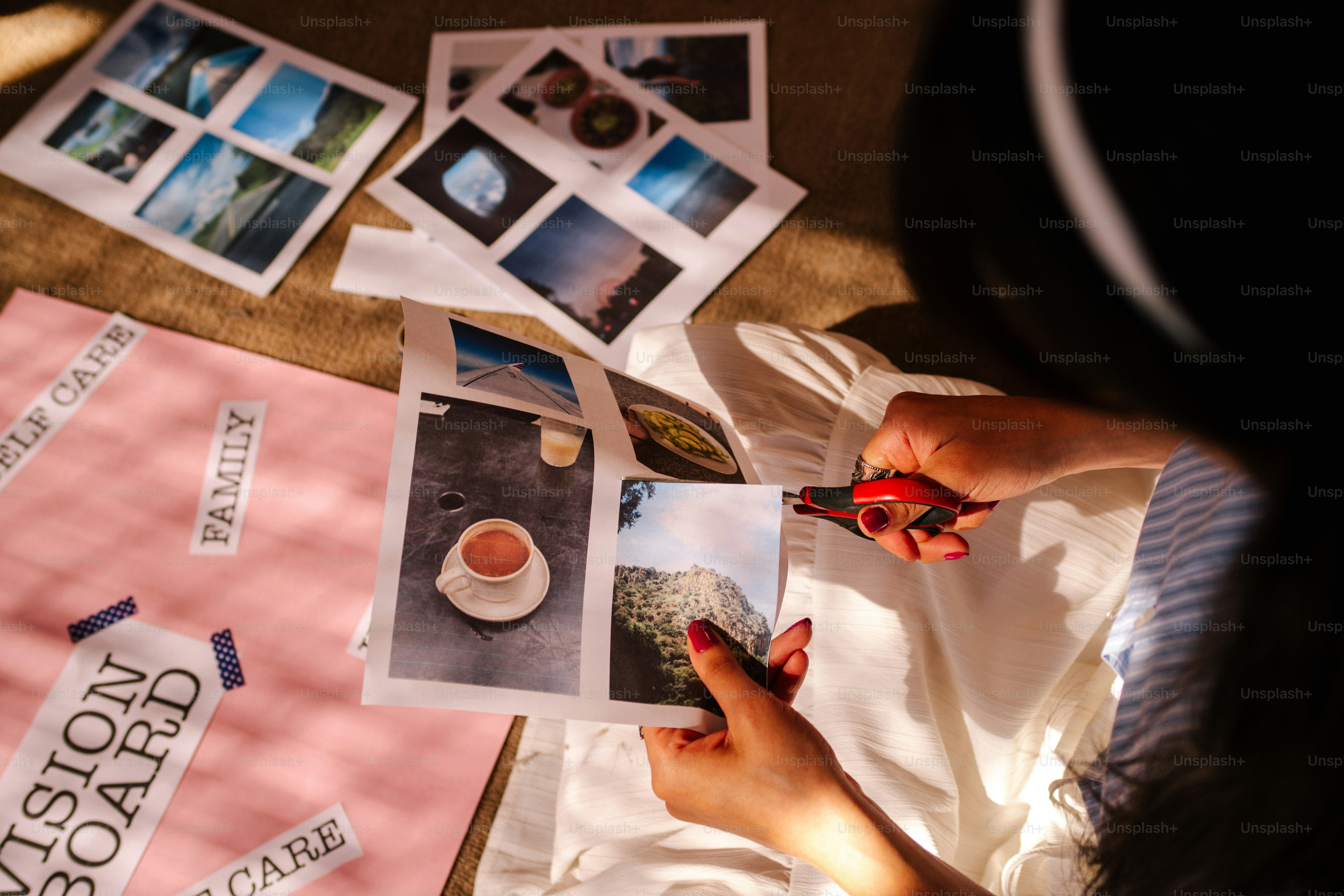 Person creating a vision board with photos and text.