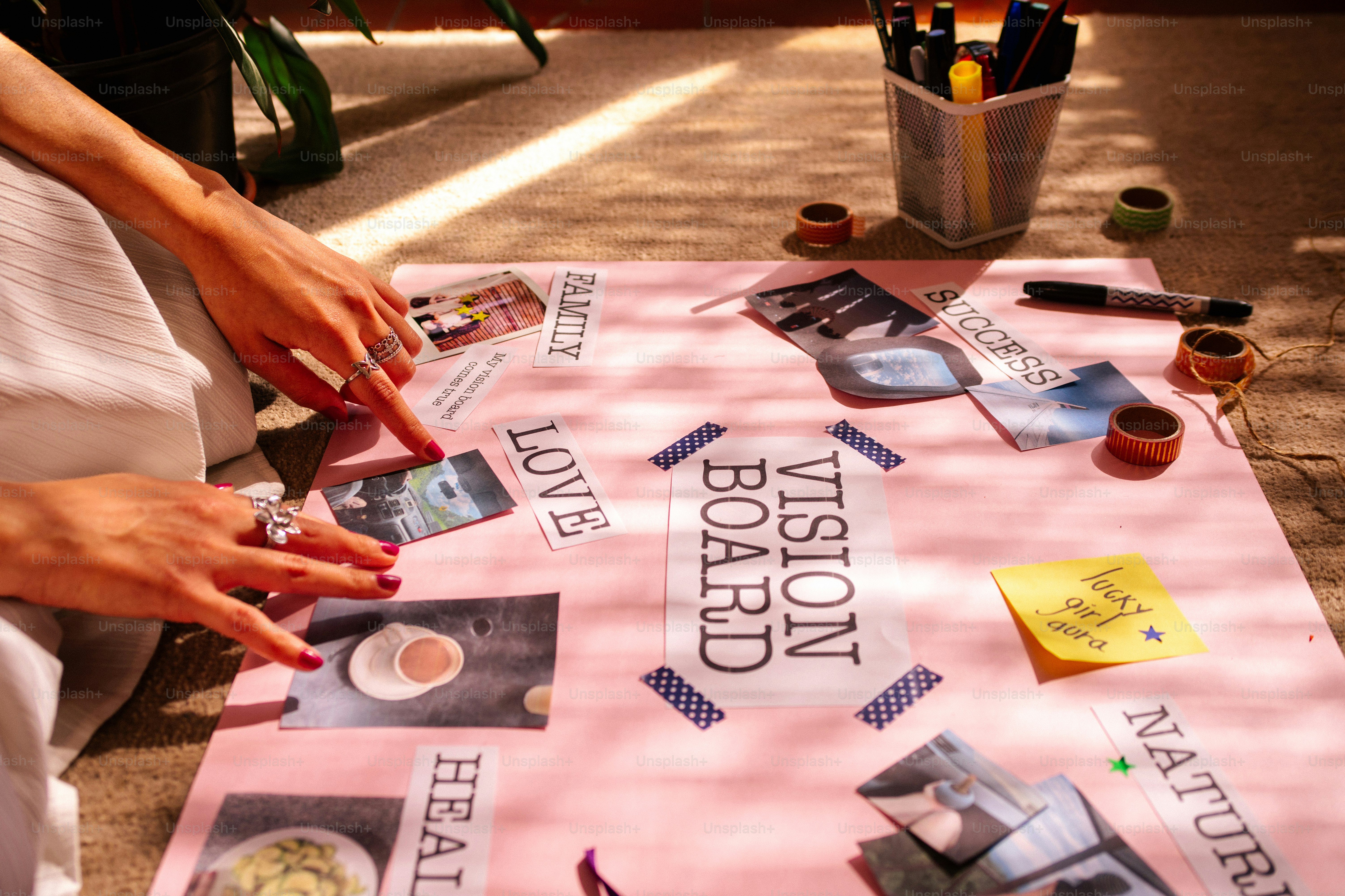 Woman creating a vision board with pictures and words.