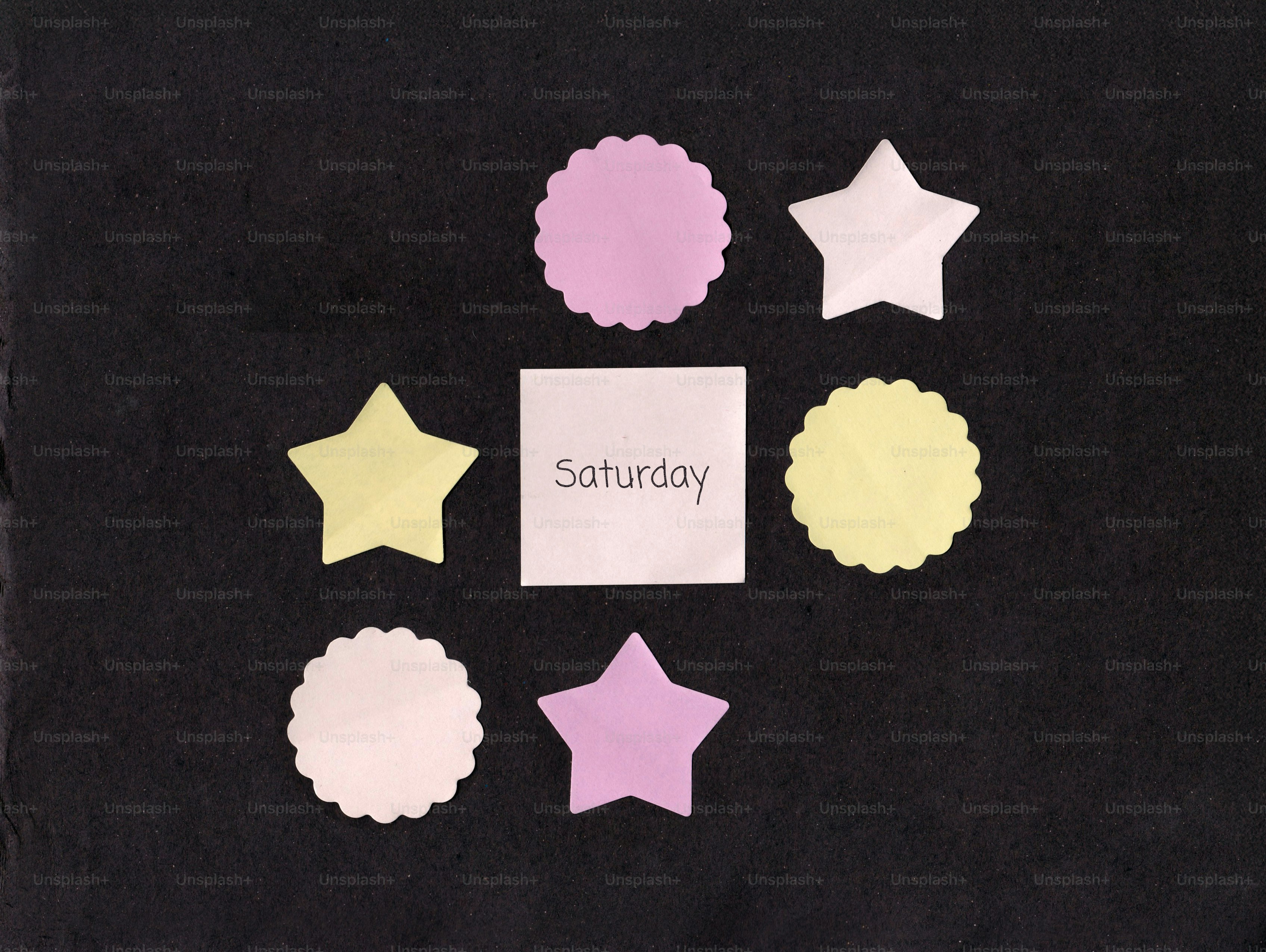 Square with 'saturday' surrounded by colorful star and scalloped shapes.