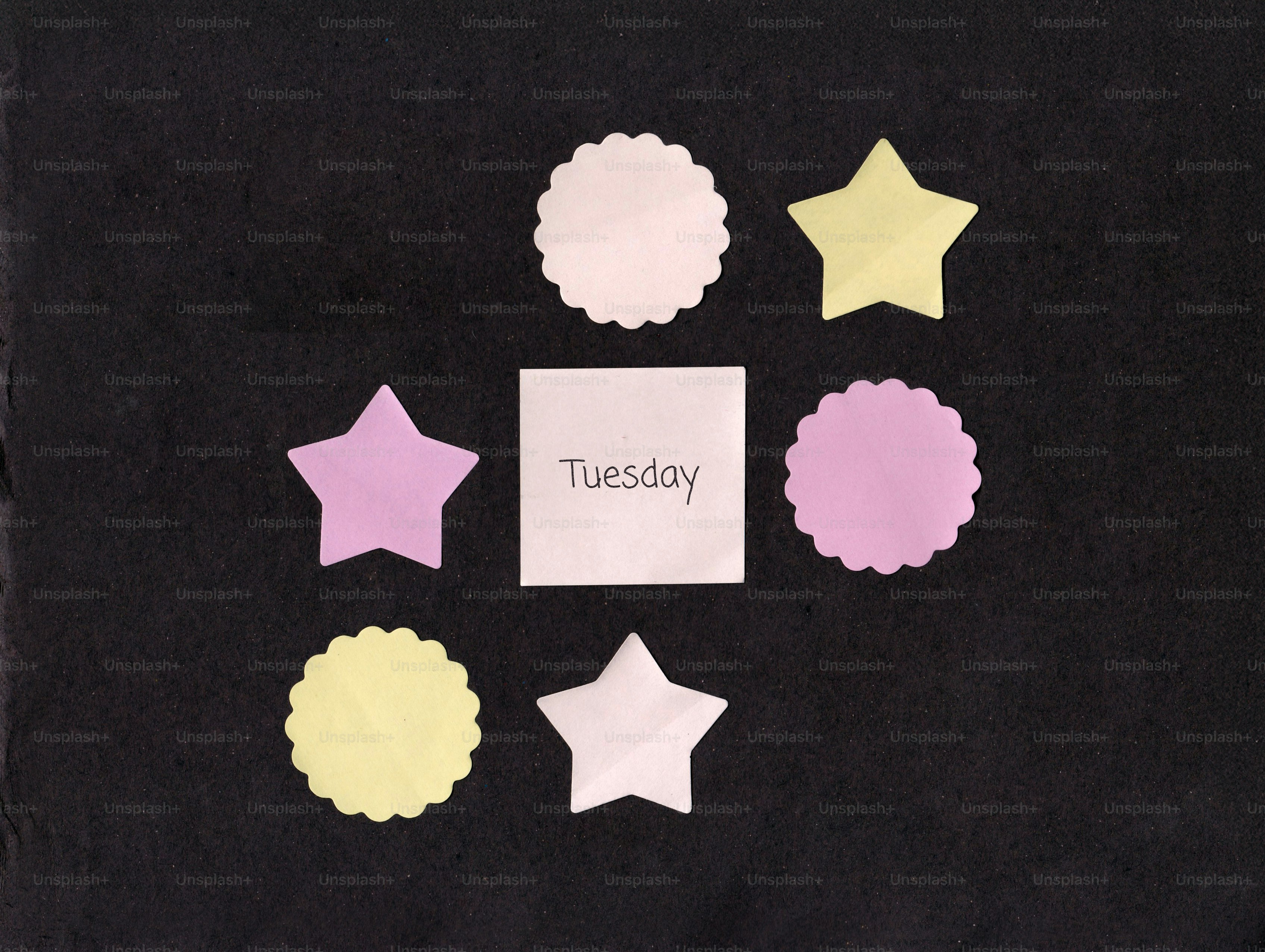 A square note with "tuesday" surrounded by stars and circles.