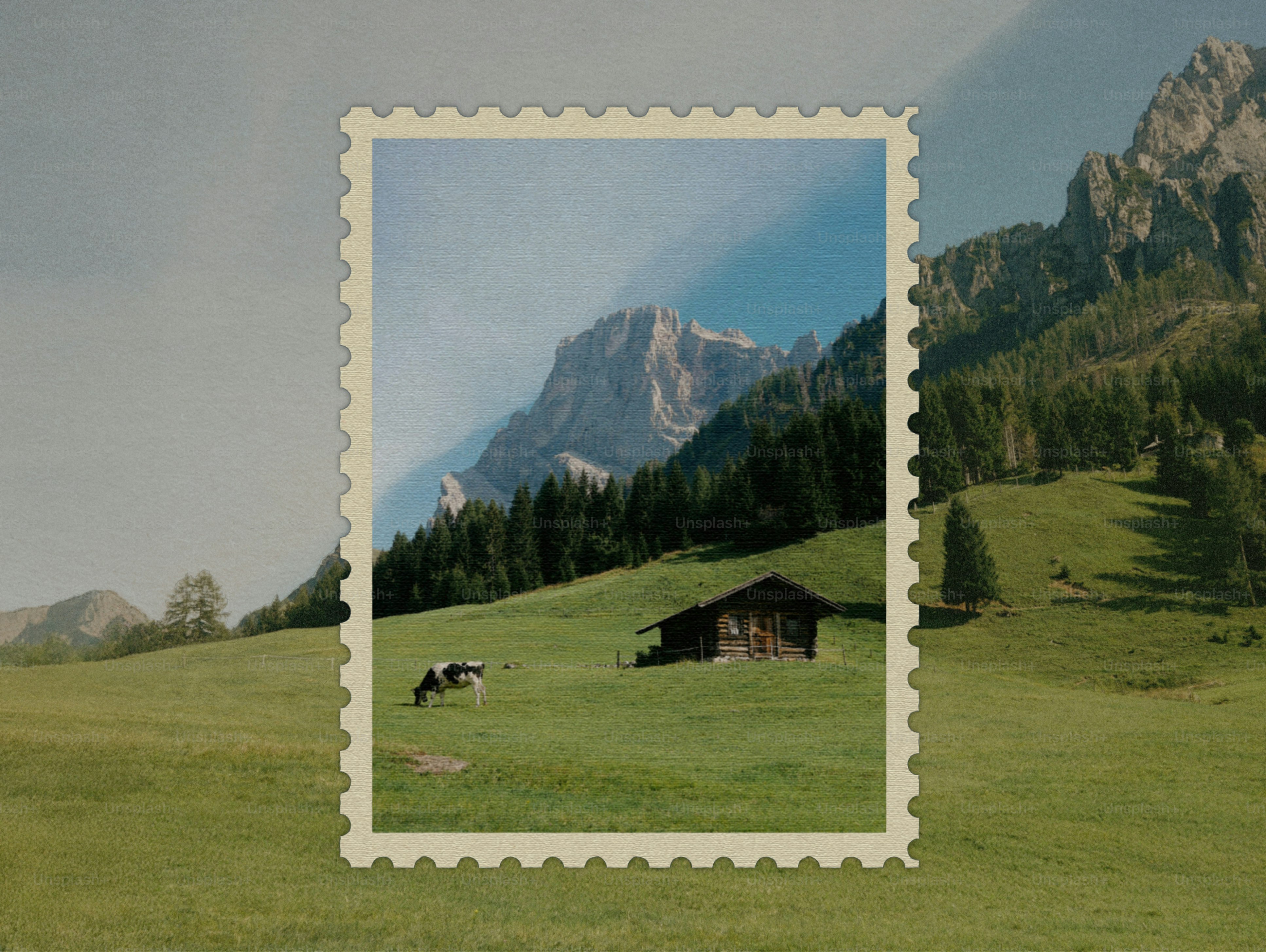 A small cabin in a green meadow with mountains.